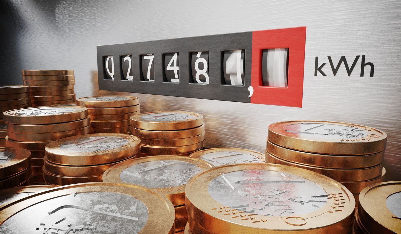 A bunch of coins are stacked on top of each other in front of a meter that says kwh.
