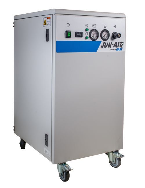 A JUN-AIR medical air compressor on wheels; grey cabinet with blue stripe, gauges, and controls.