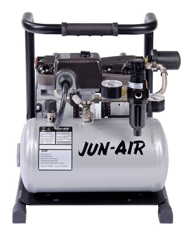 A small, silver Jun-Air air compressor with black handle, frame, and components.