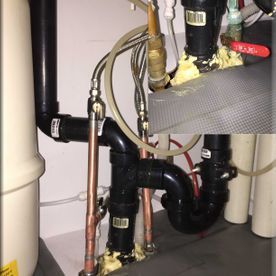 A close up of a bathroom sink with a lot of pipes.