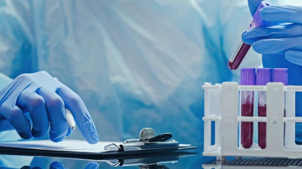 People practicing CPR on mannequins in a classroom.