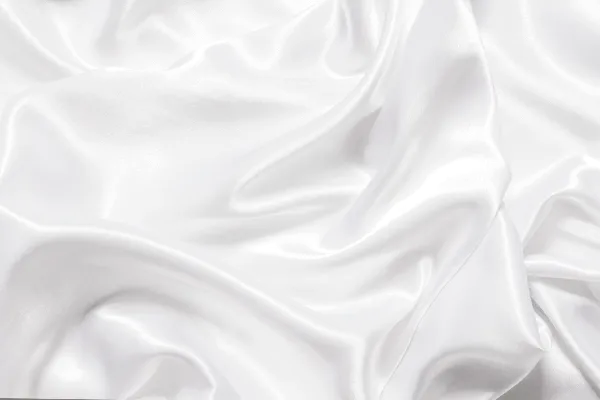 White satin fabric with soft folds and highlights.