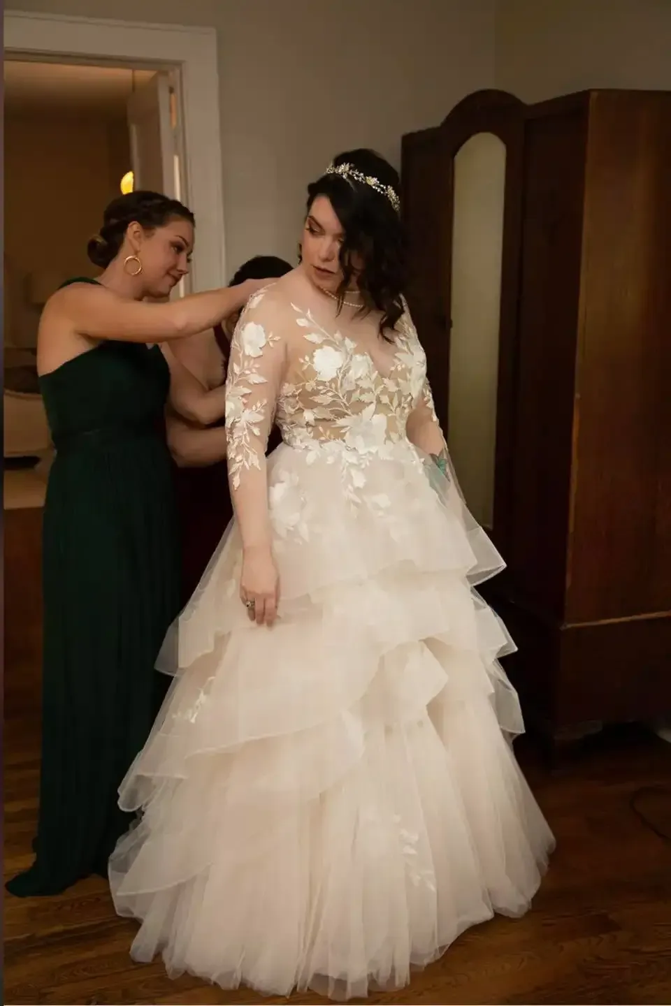 A bride is getting ready for her wedding with her bridesmaids.
