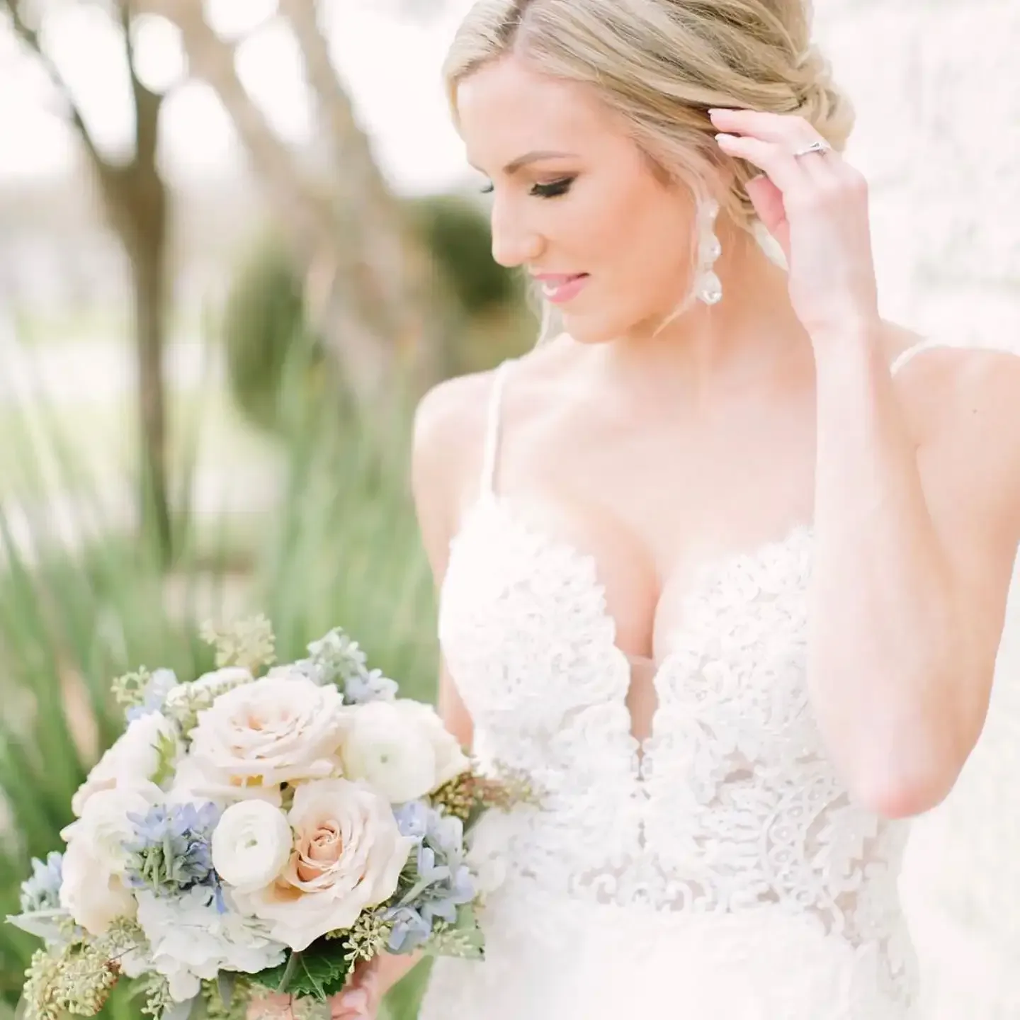 A bride in a white dress is holding a bouquet of flowers.