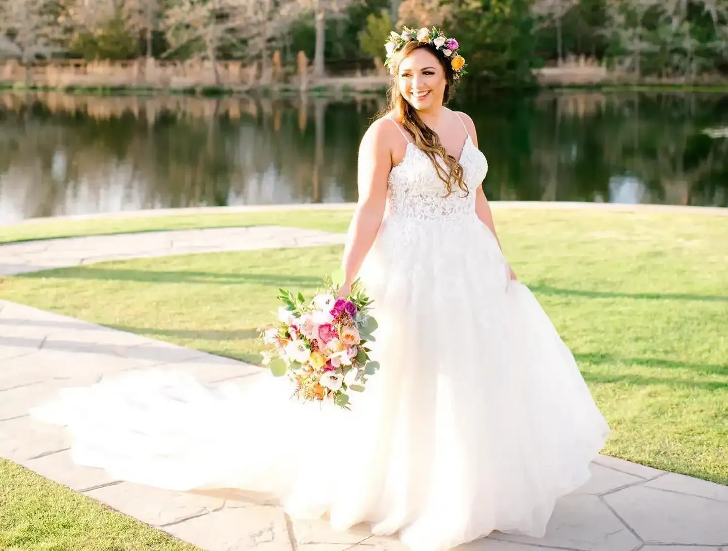 The bride is wearing a flower crown and holding a bouquet of flowers.