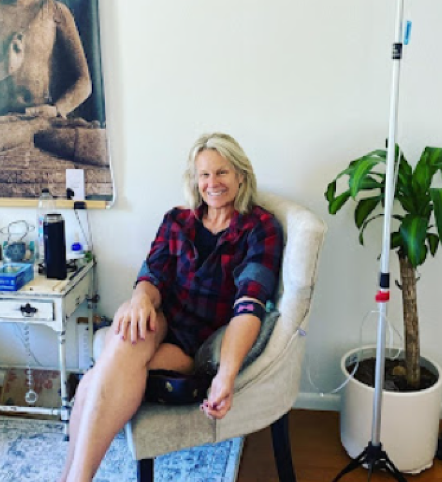 A woman in a plaid shirt is sitting in a chair