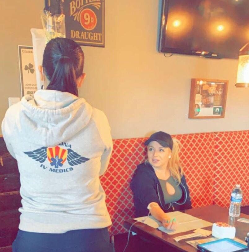 A woman wearing a hoodie that says fly medics