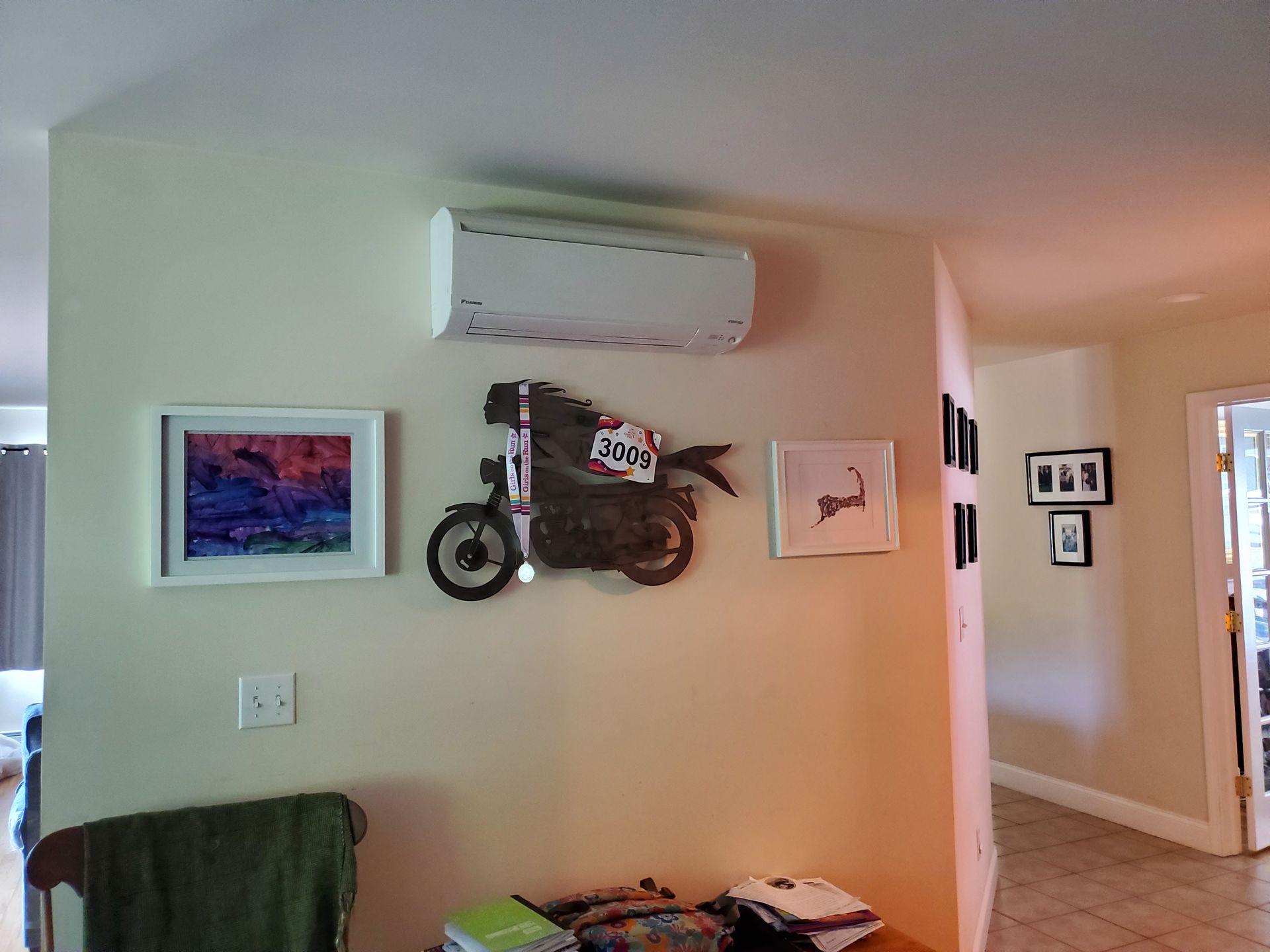A motorcycle is hanging on a wall in a living room.