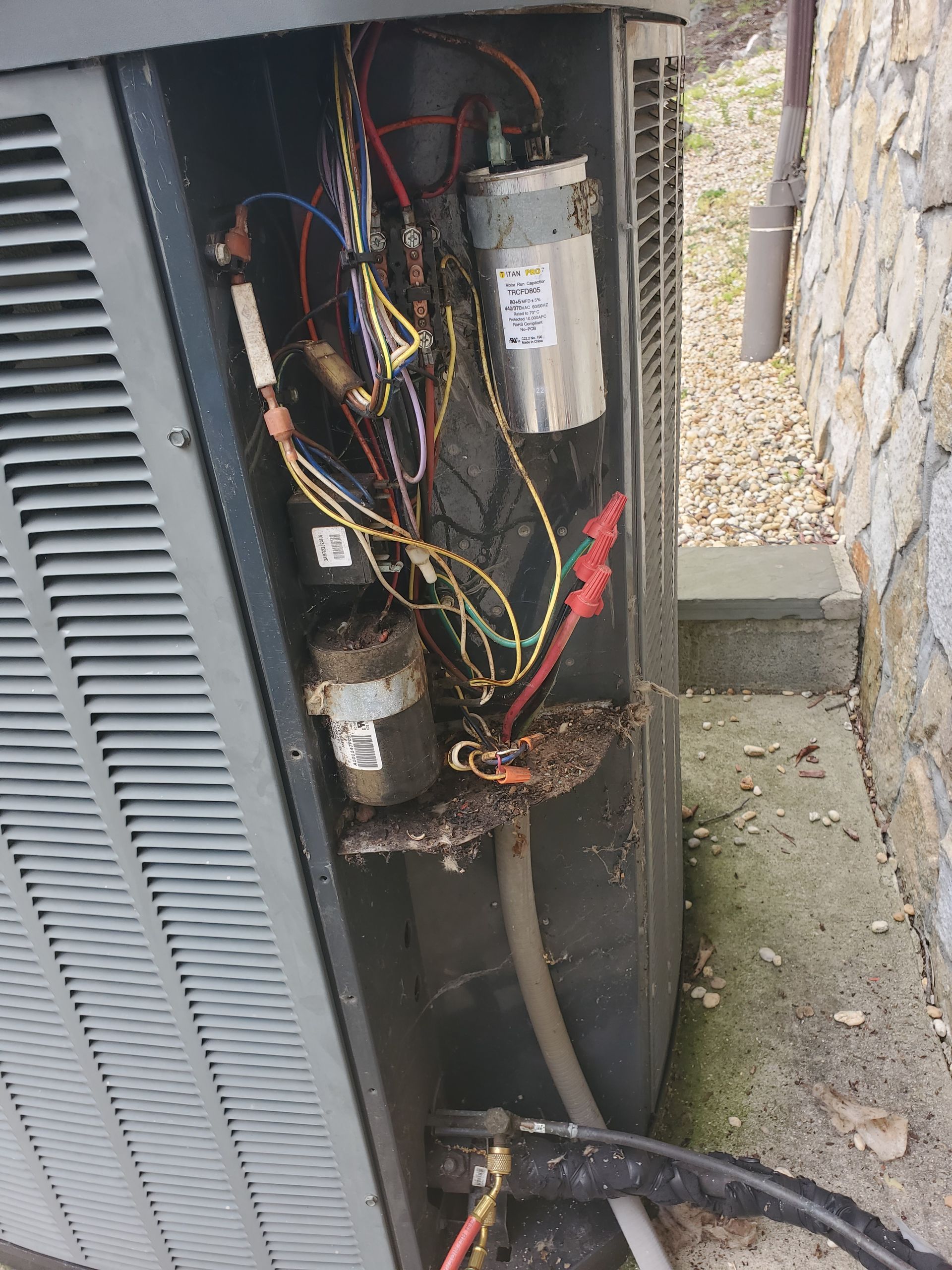The inside of an air conditioner with a lot of wires coming out of it.
