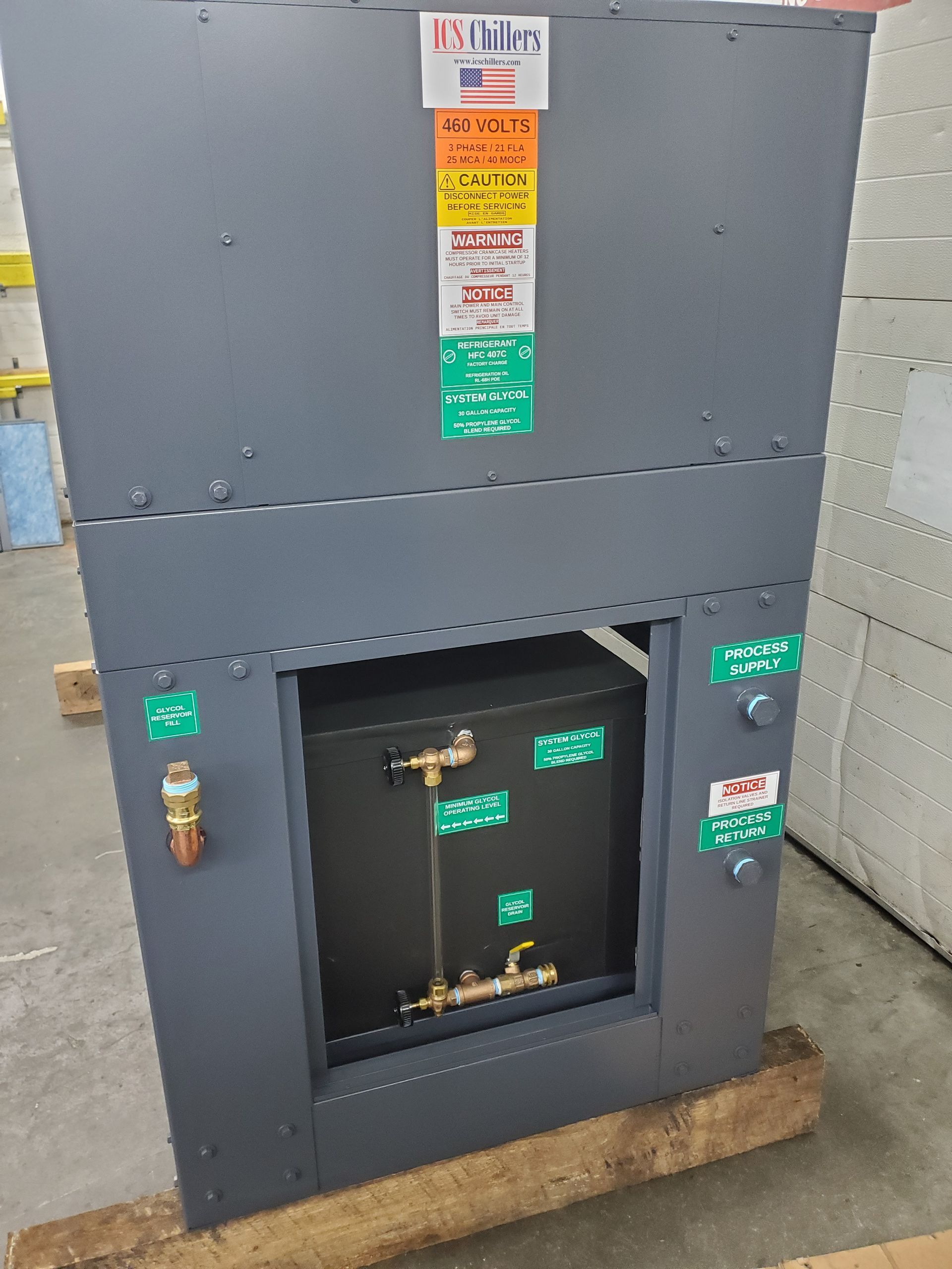 A large black box is sitting on top of a wooden pallet.