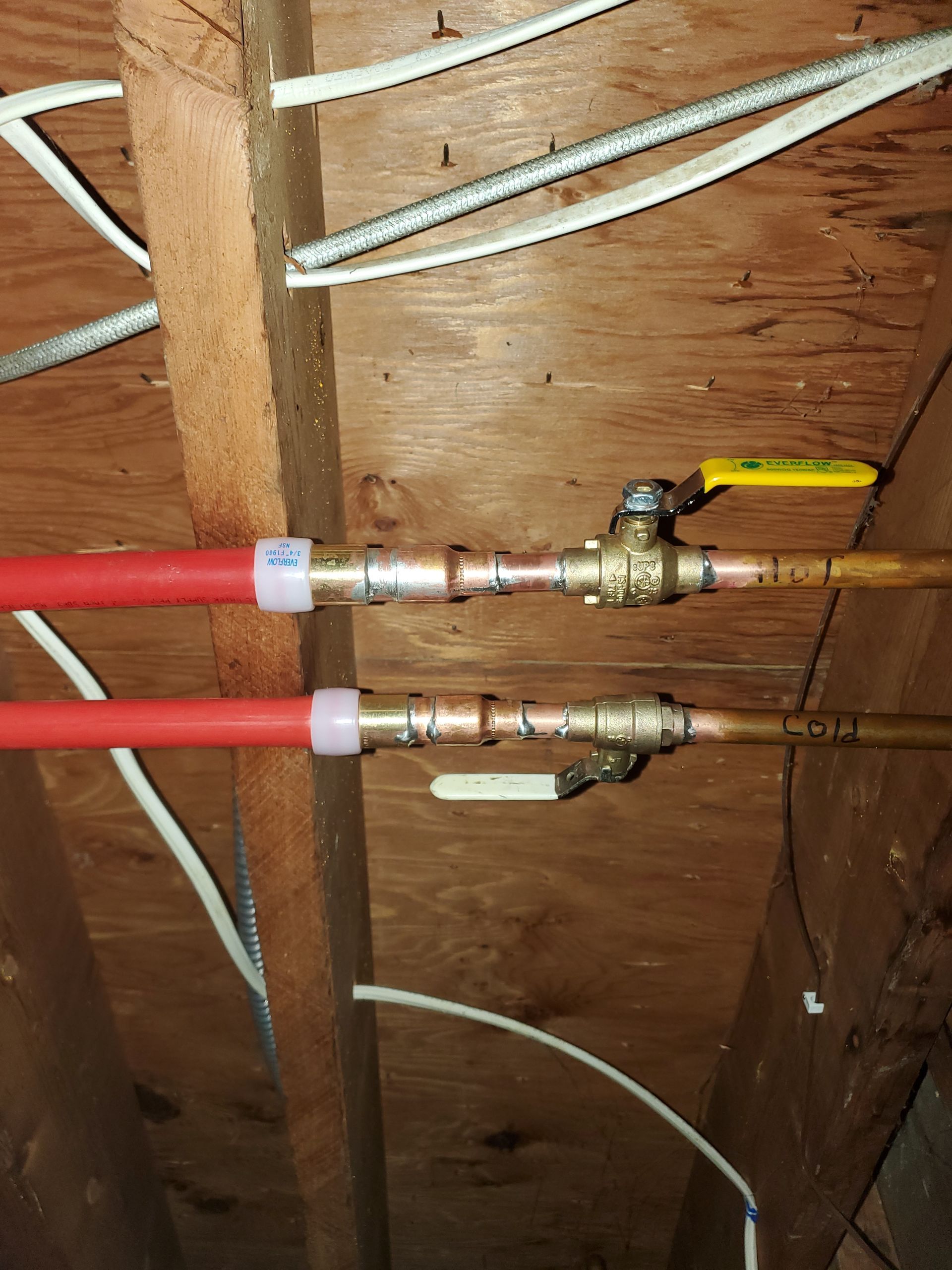 A bunch of pipes are connected to each other in a wooden room.