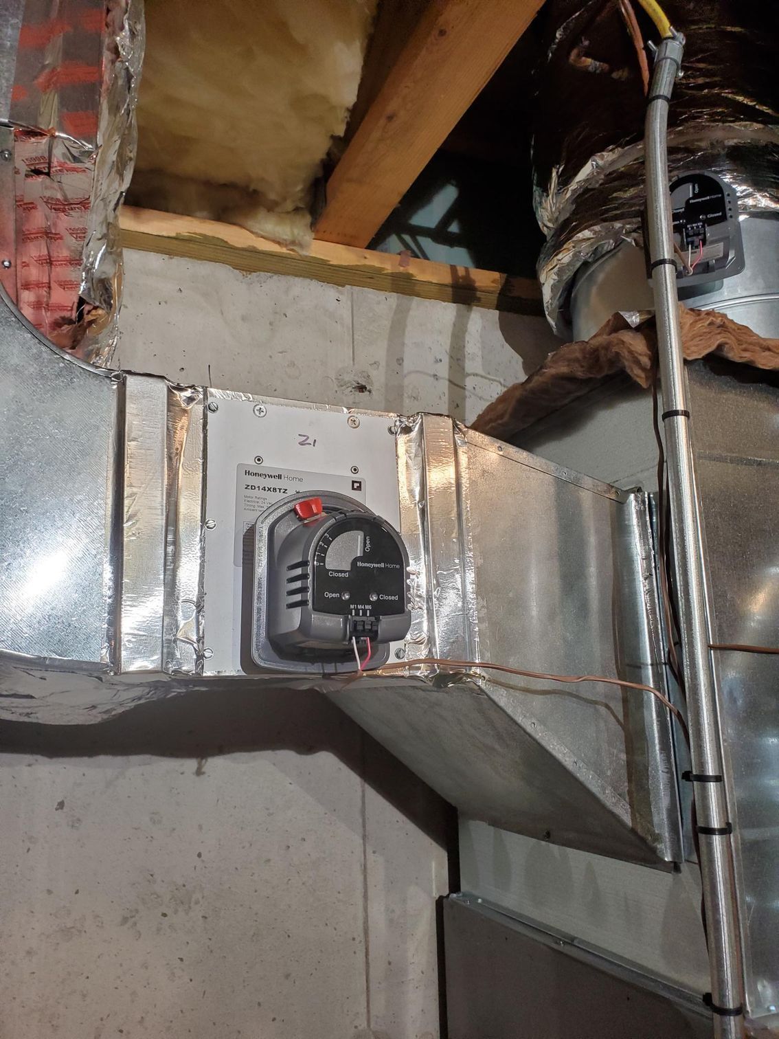 A close up of a metal duct with a switch on it.