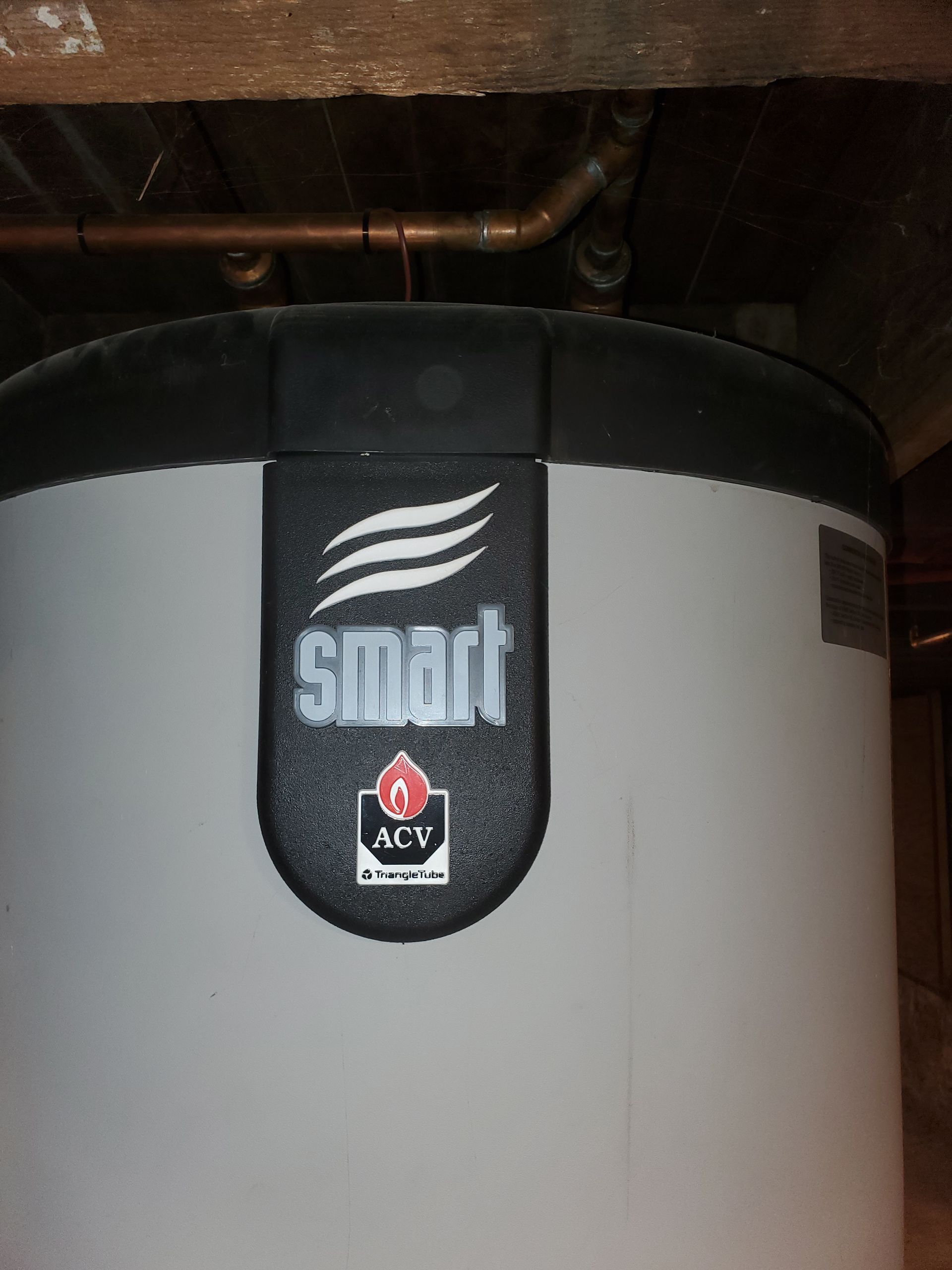 A smart water heater is sitting under a wooden ceiling