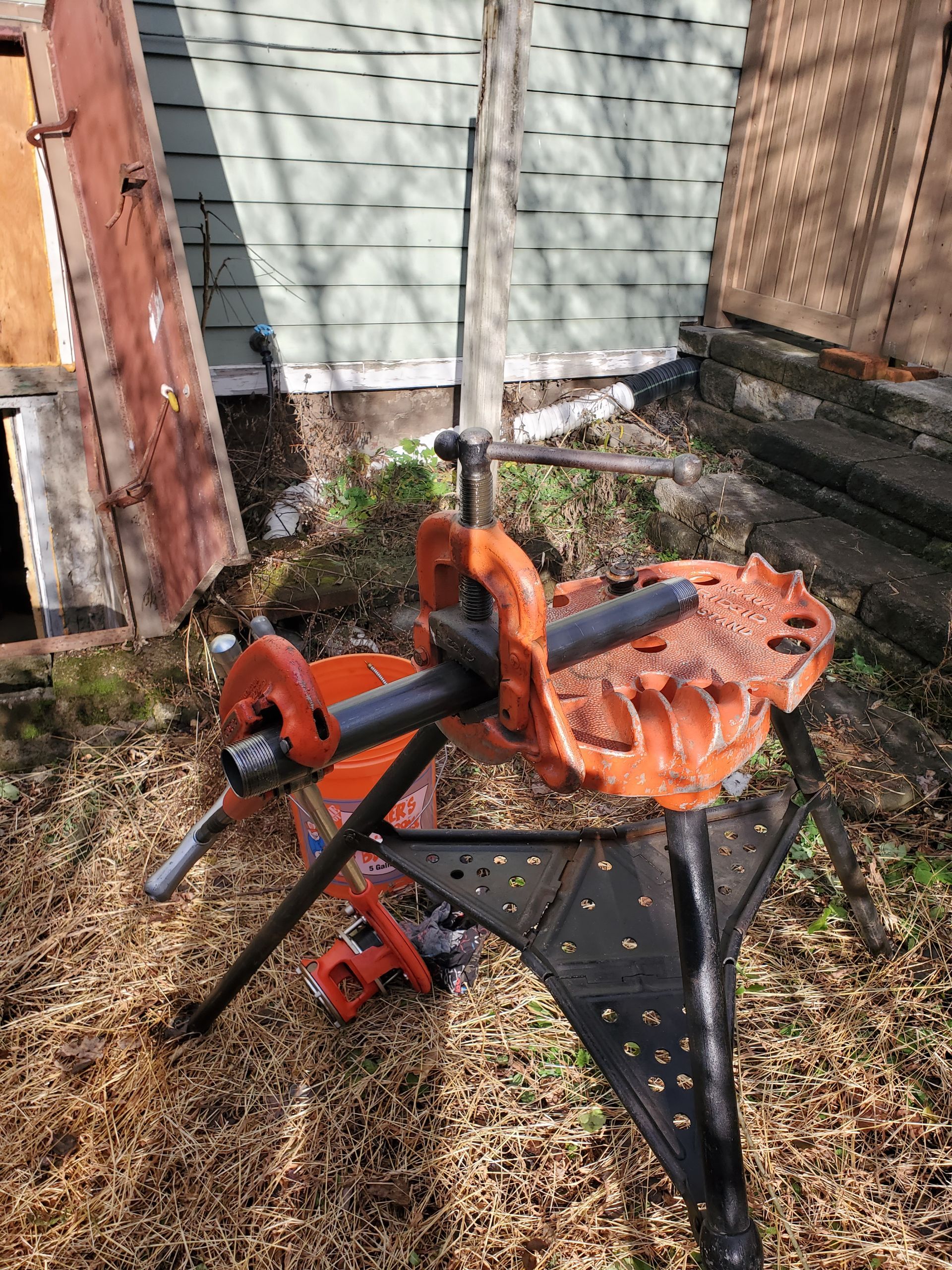A pipe vise is sitting on top of a workbench.