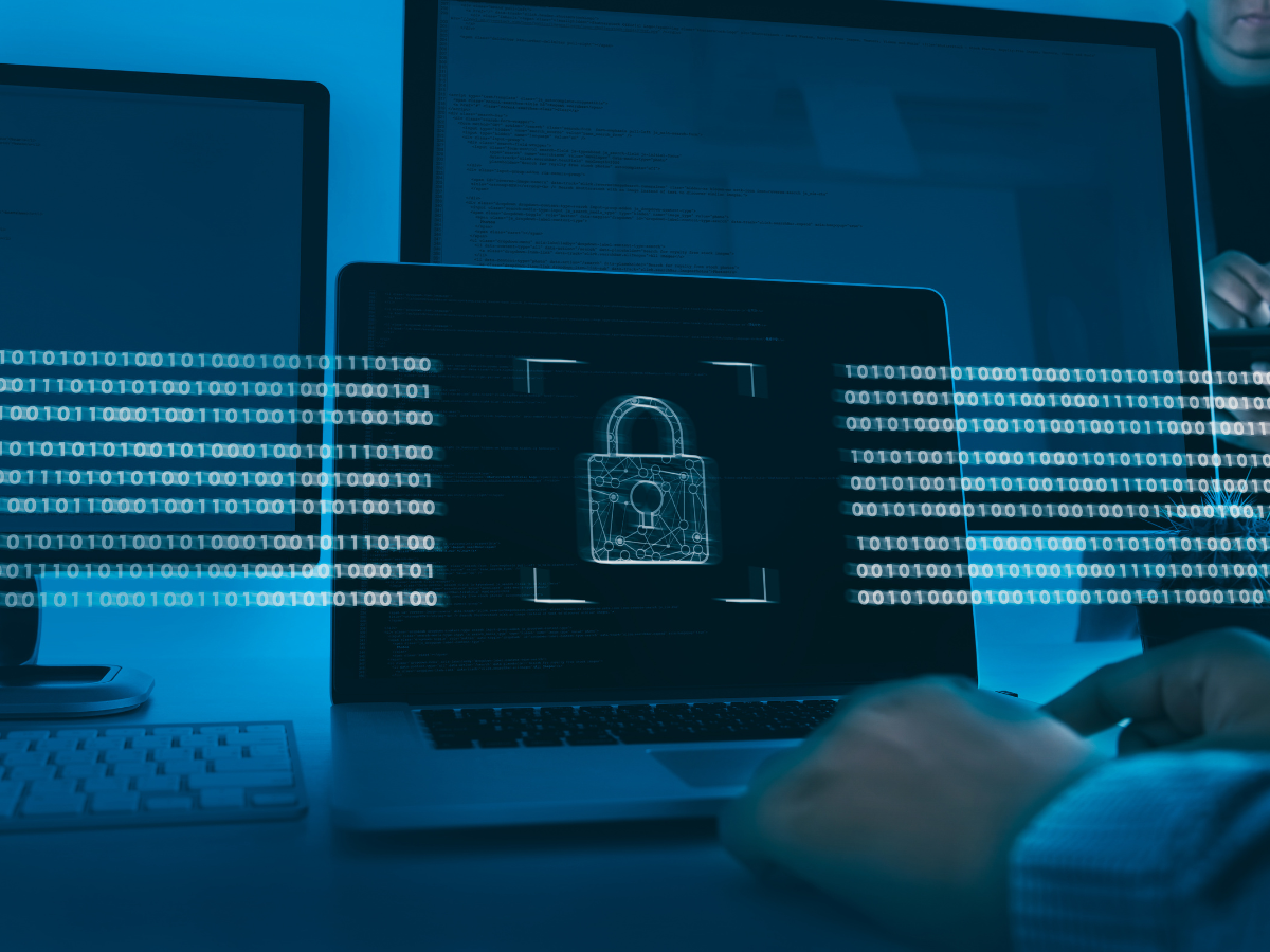 A person is typing on a laptop with a padlock on the screen