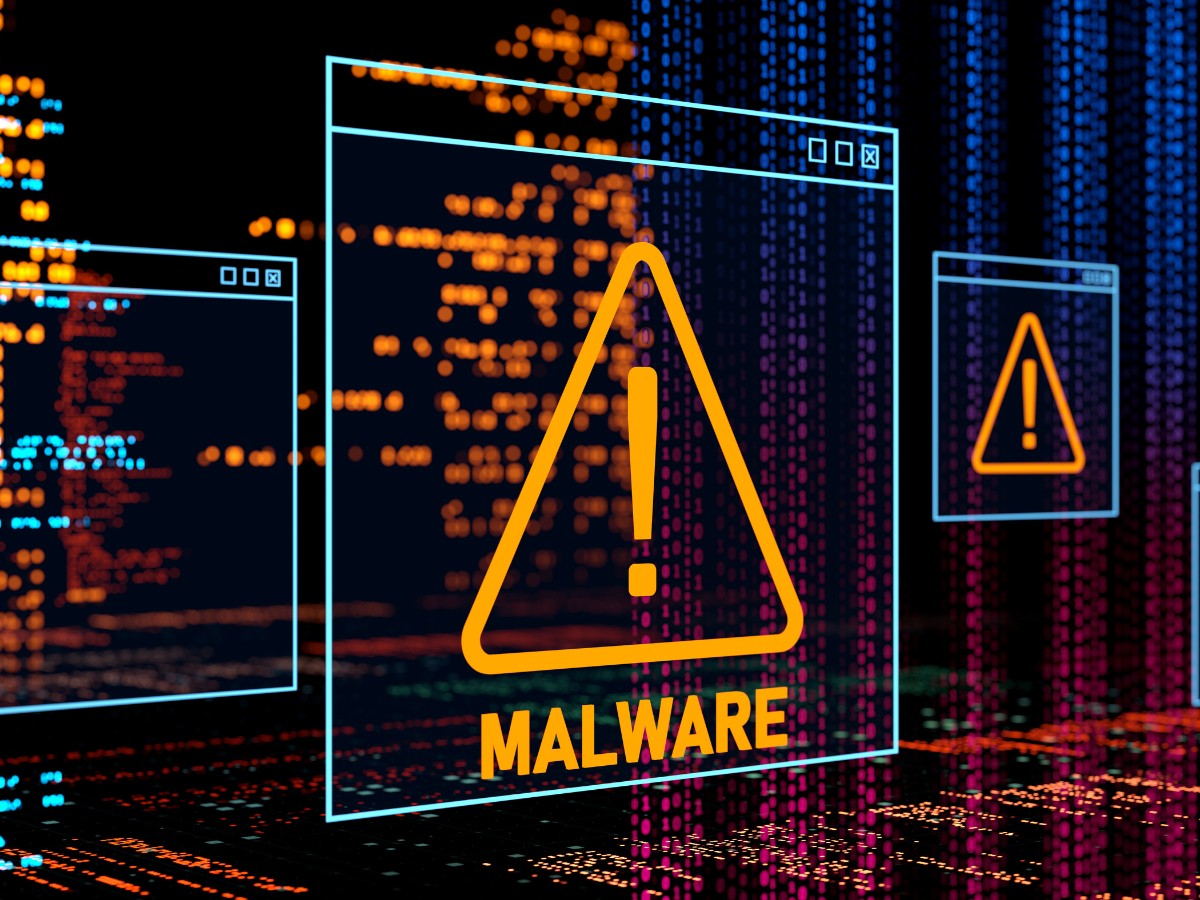 A computer screen with a warning sign and the word malware on it