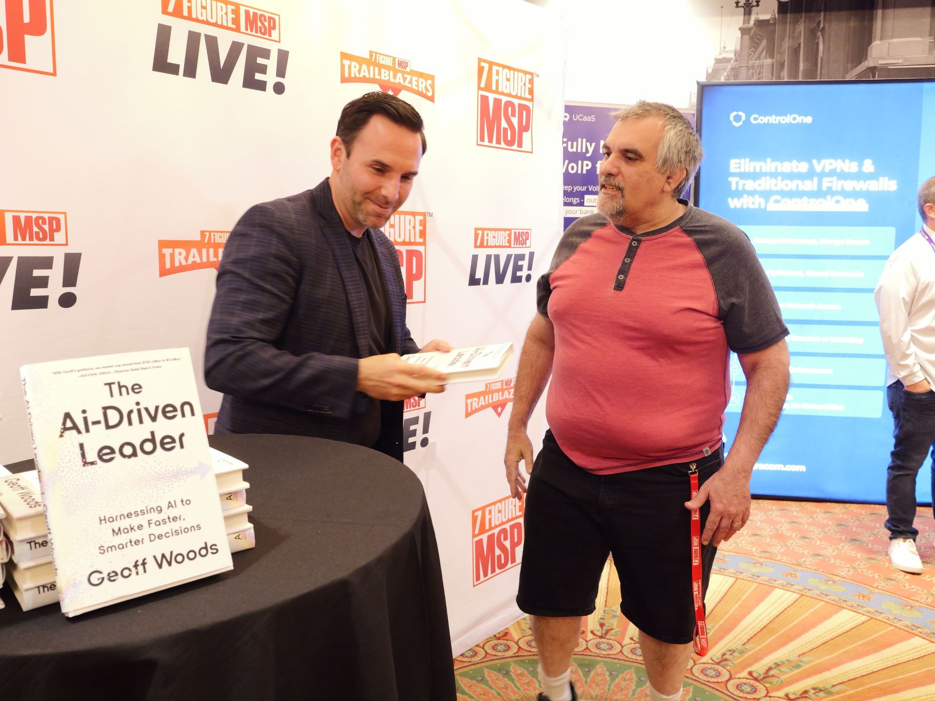 Two men are standing in front of a sign that says the ai-driven leader