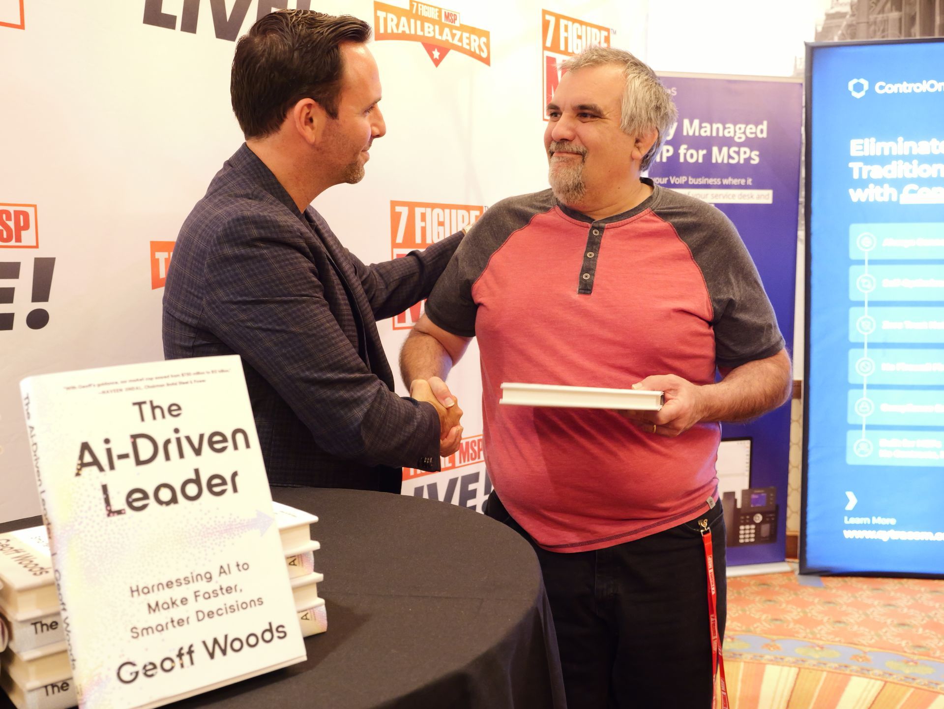 Two men shaking hands in front of a sign that says the ai-driven leader