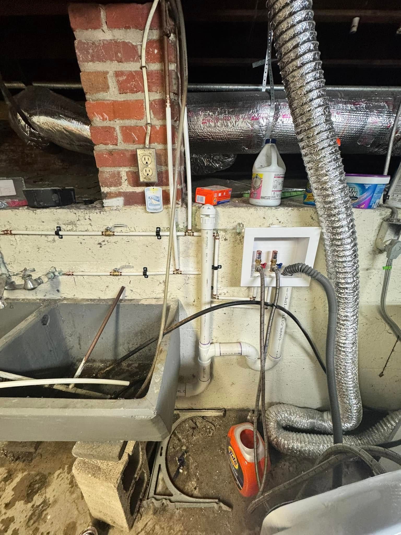 Laundry room with concrete sink, washing machine hookups, and dryer vent.