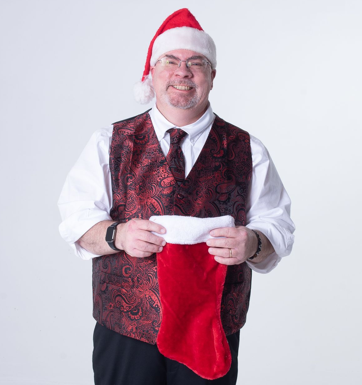 The man is in a red and white Santa suit with snowmen in the background. 