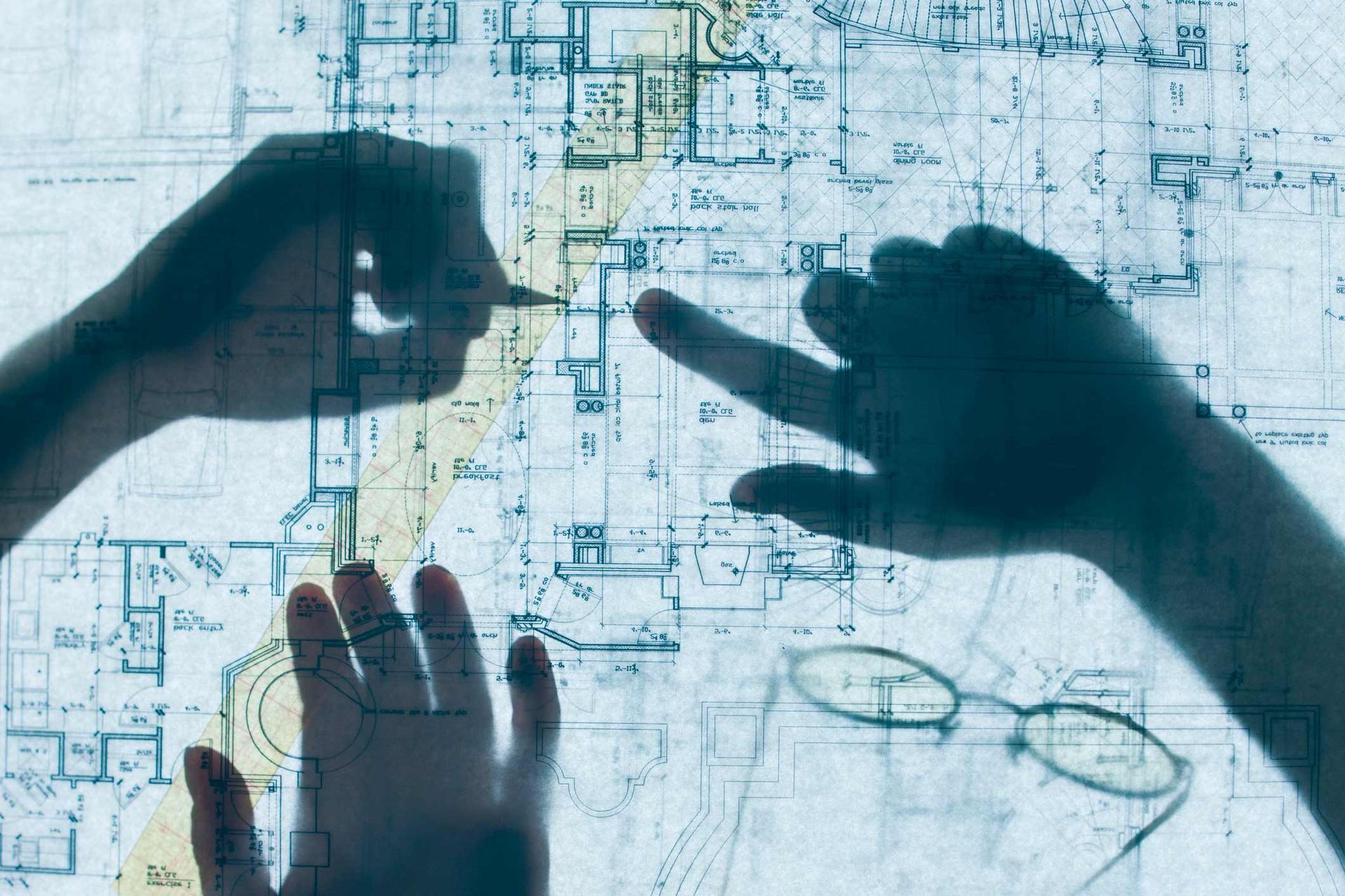 Shadow of hands on a blueprint | Sydney, NSW | Soilsrock Engineering Pty Ltd