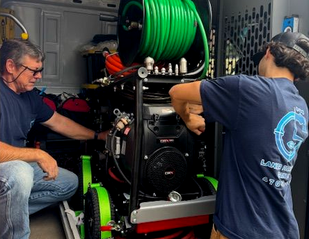Wrench, brass fittings, and red valve on a wet, blue surface, likely representing plumbing or repair work.