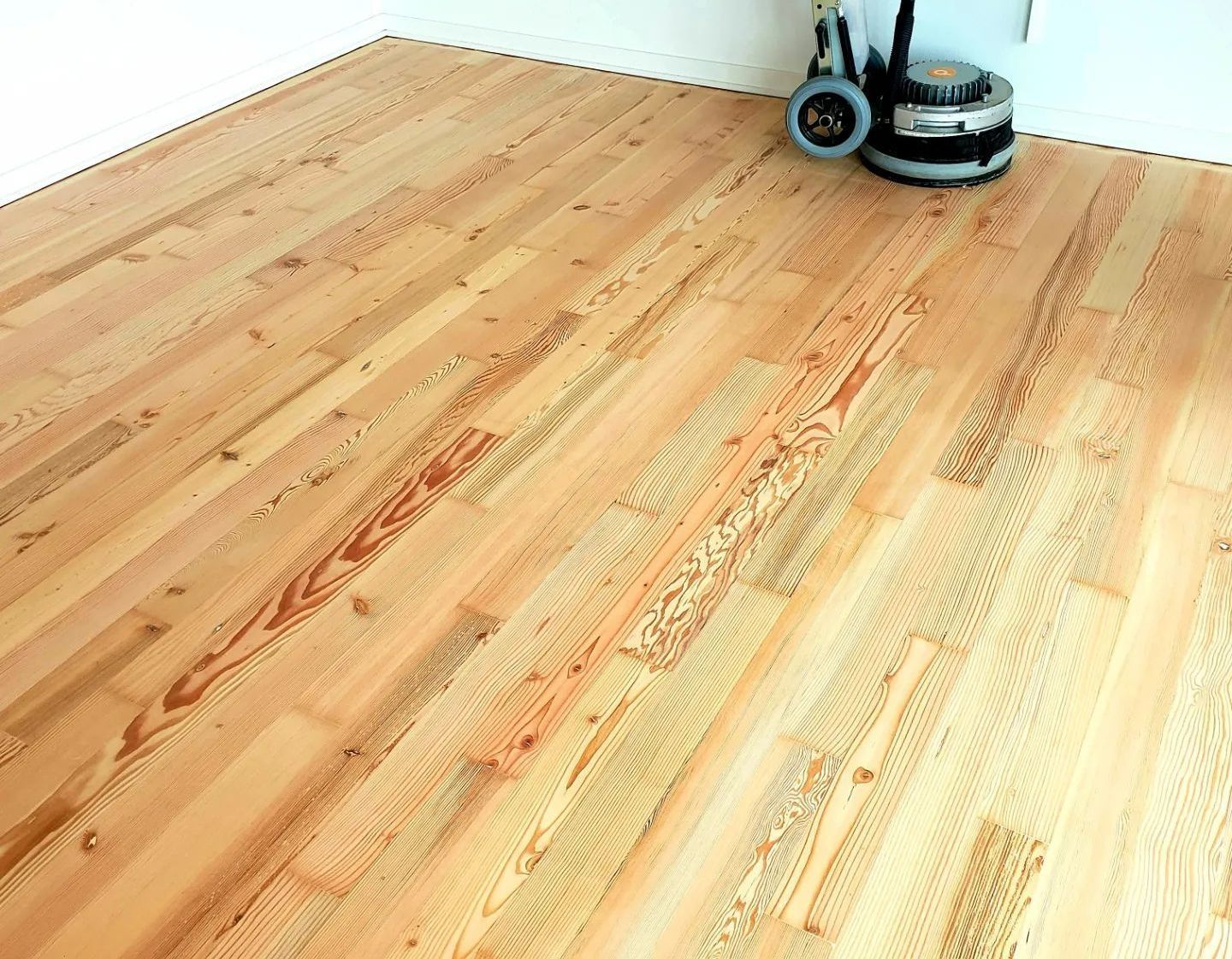 A wooden floor with a vacuum cleaner on it.