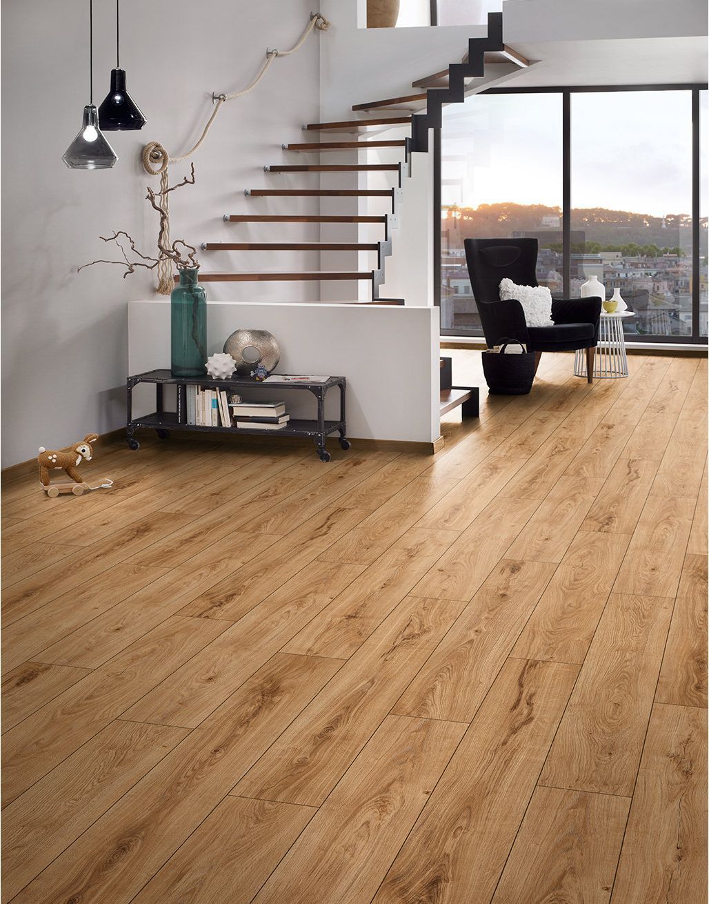 A living room with a wooden floor and stairs