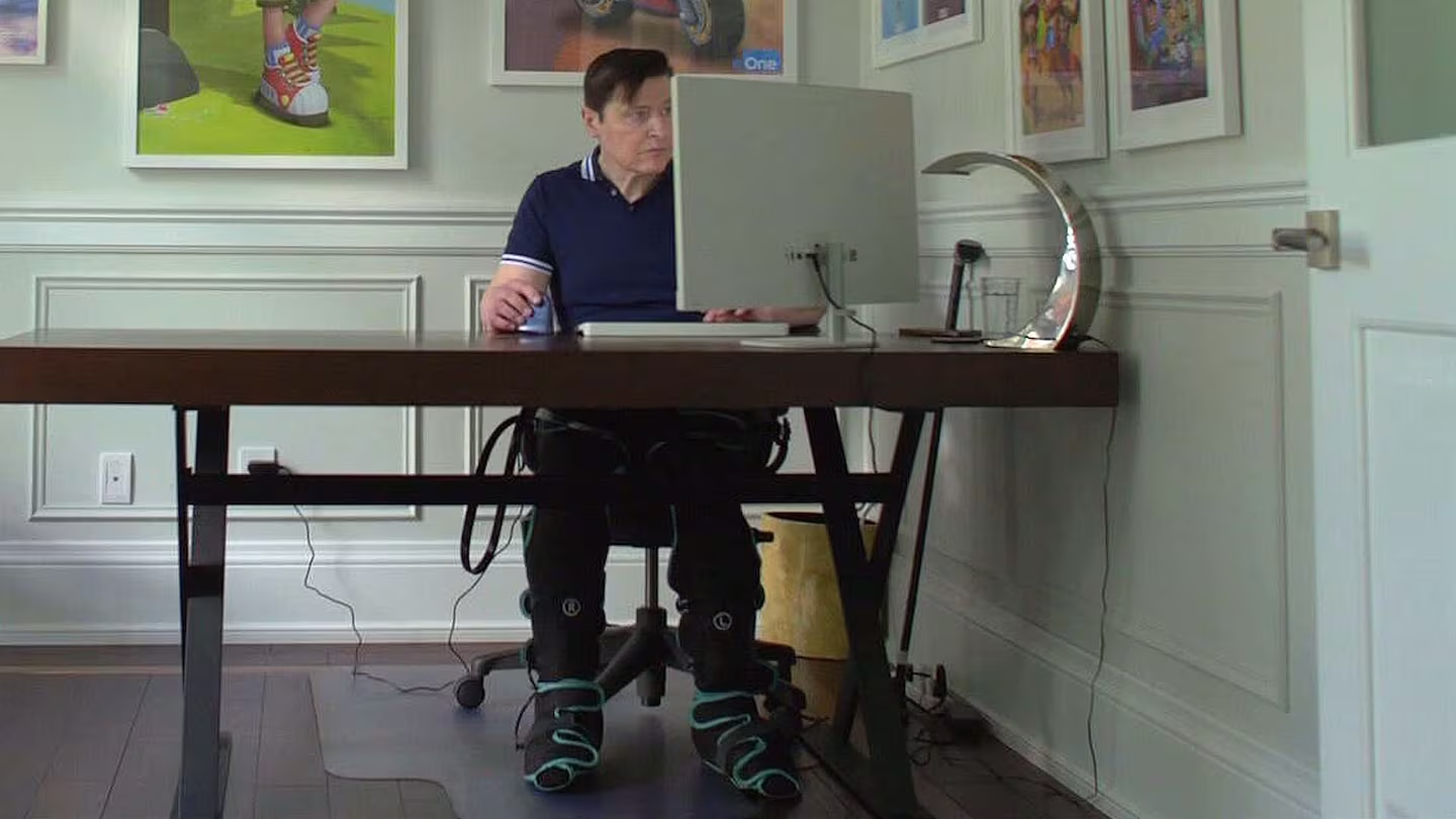 A person sitting at a desk working on a computer.