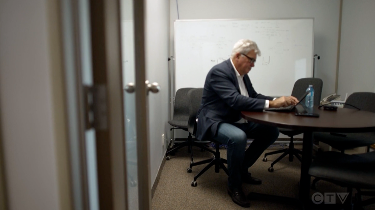Image of a man sitting at a table
