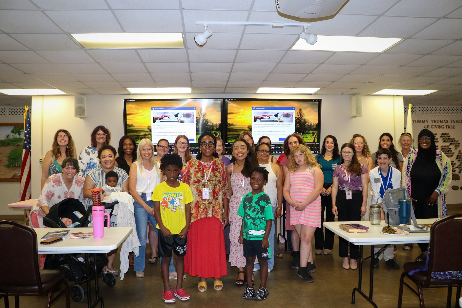 A group of people are posing for a picture in a room.
