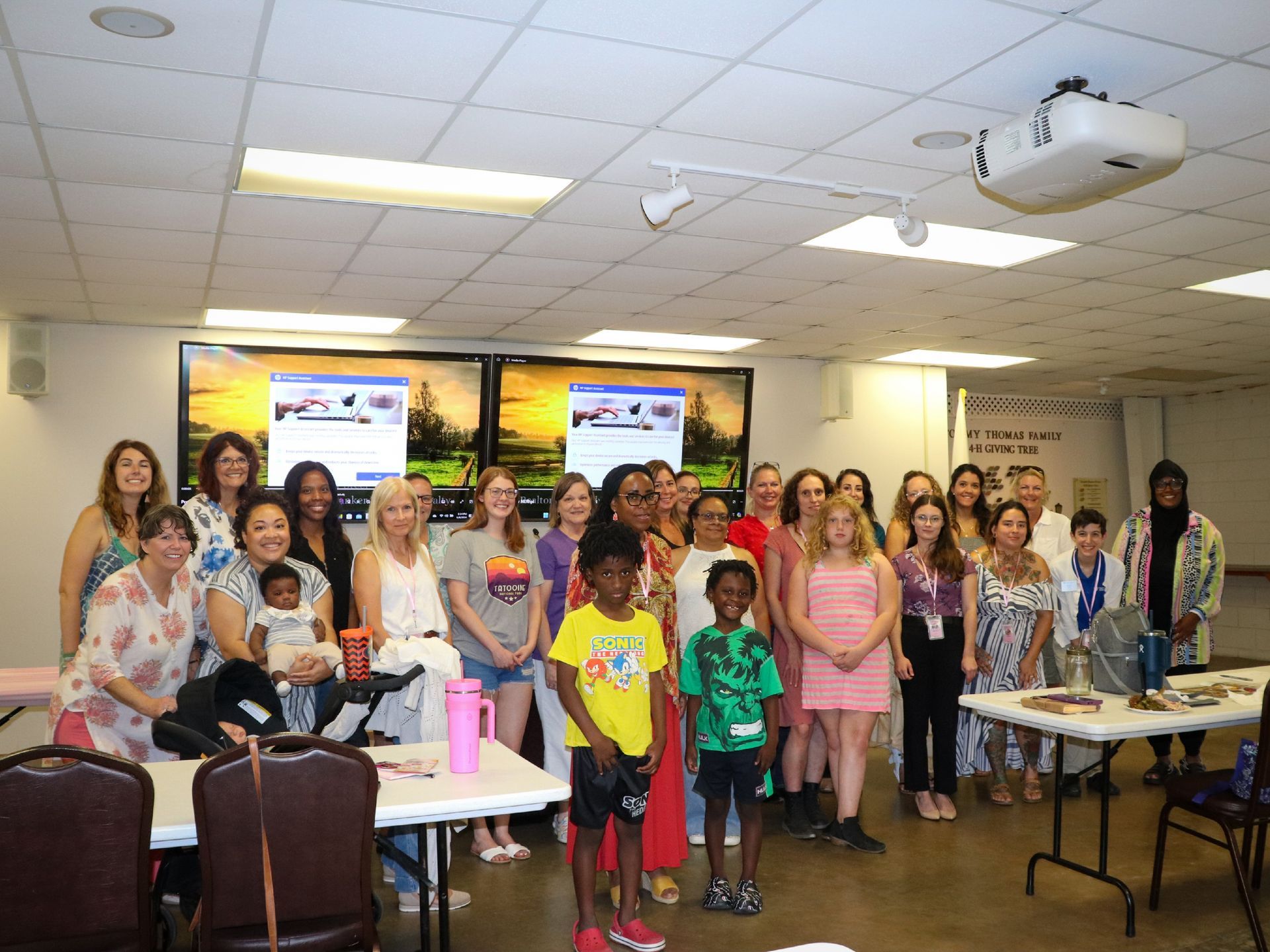 A group of people are posing for a picture in a room.