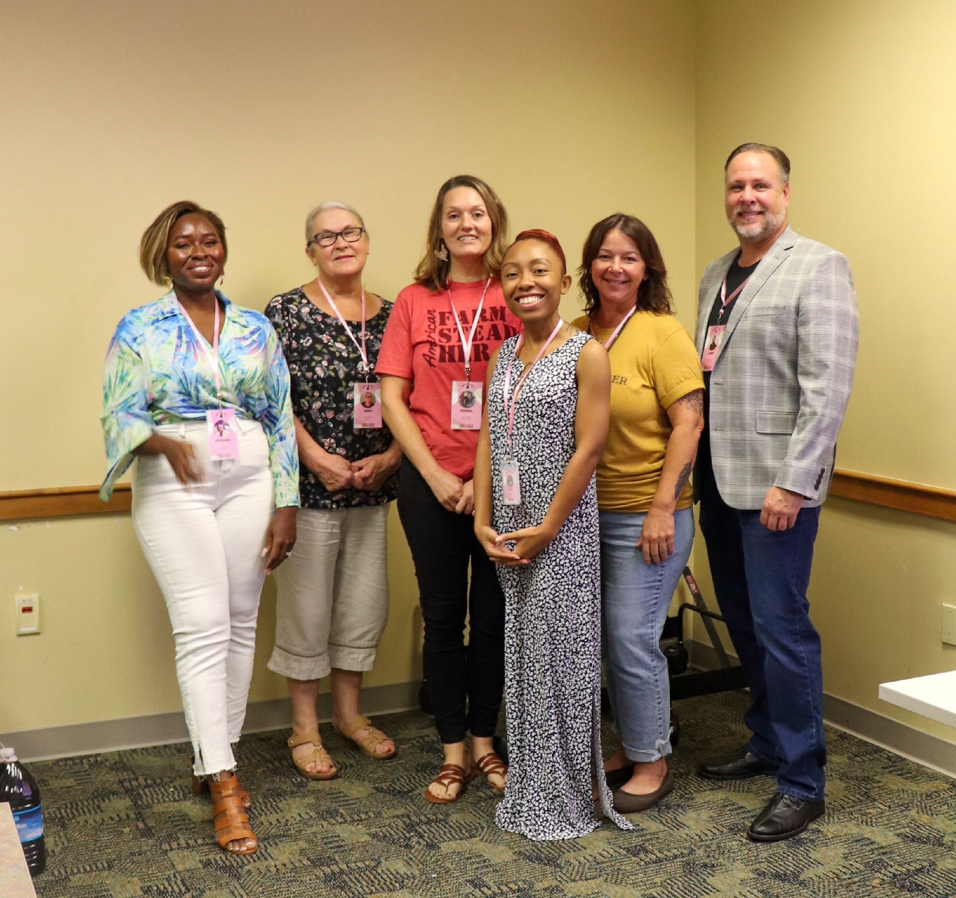 A group of people are posing for a picture in a room.