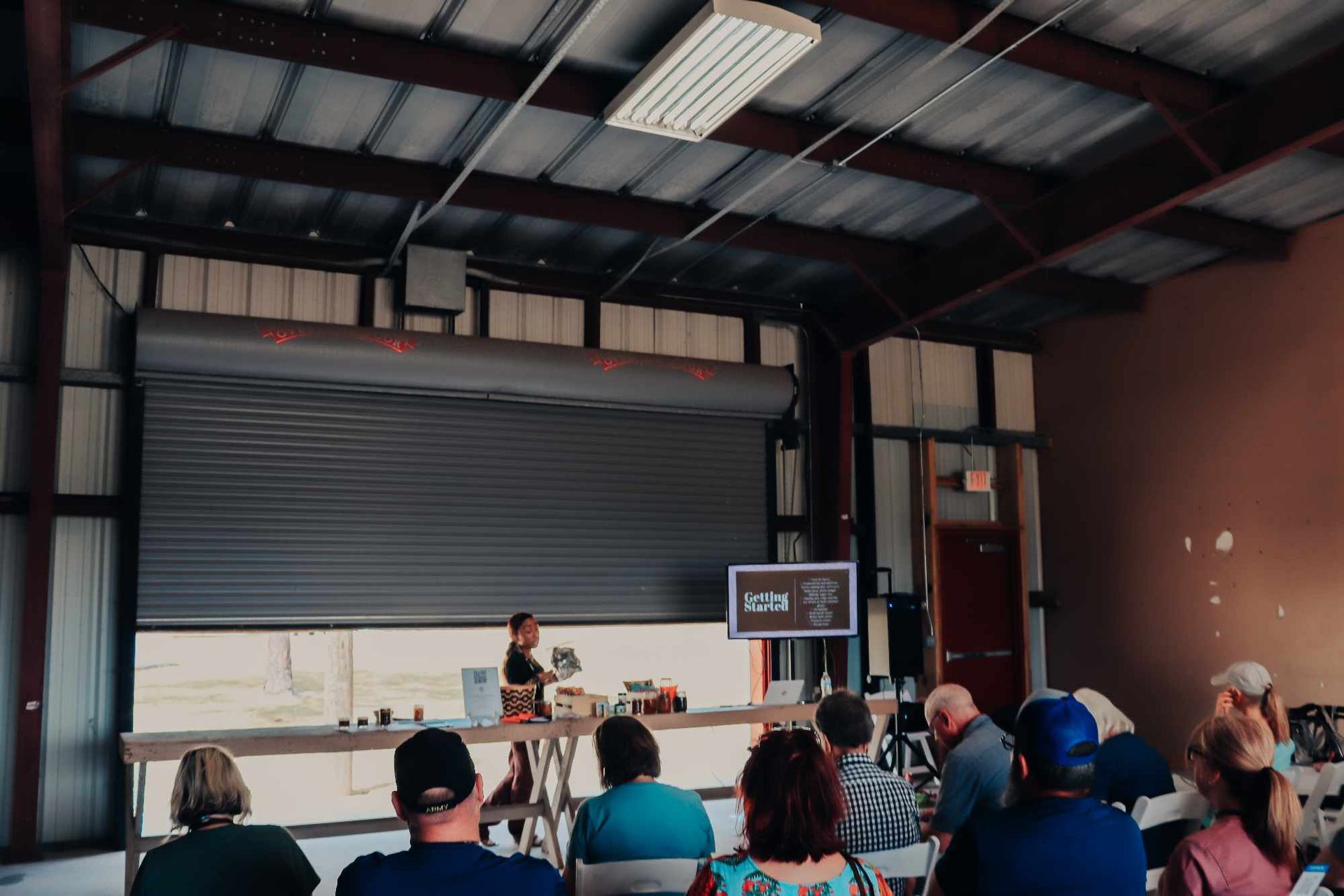 A group of people are sitting in a room watching a presentation.