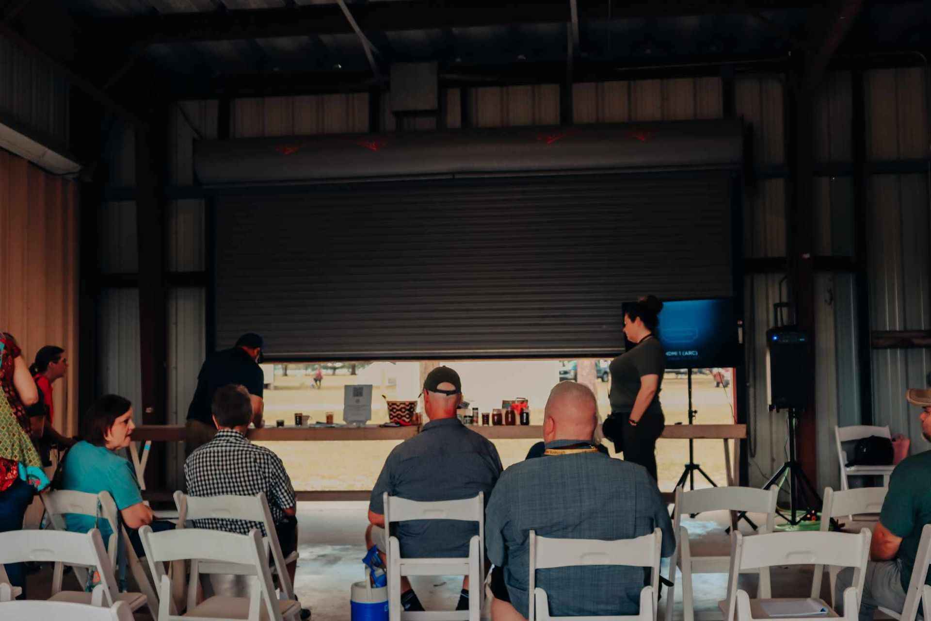 A group of people are sitting in chairs in a room.
