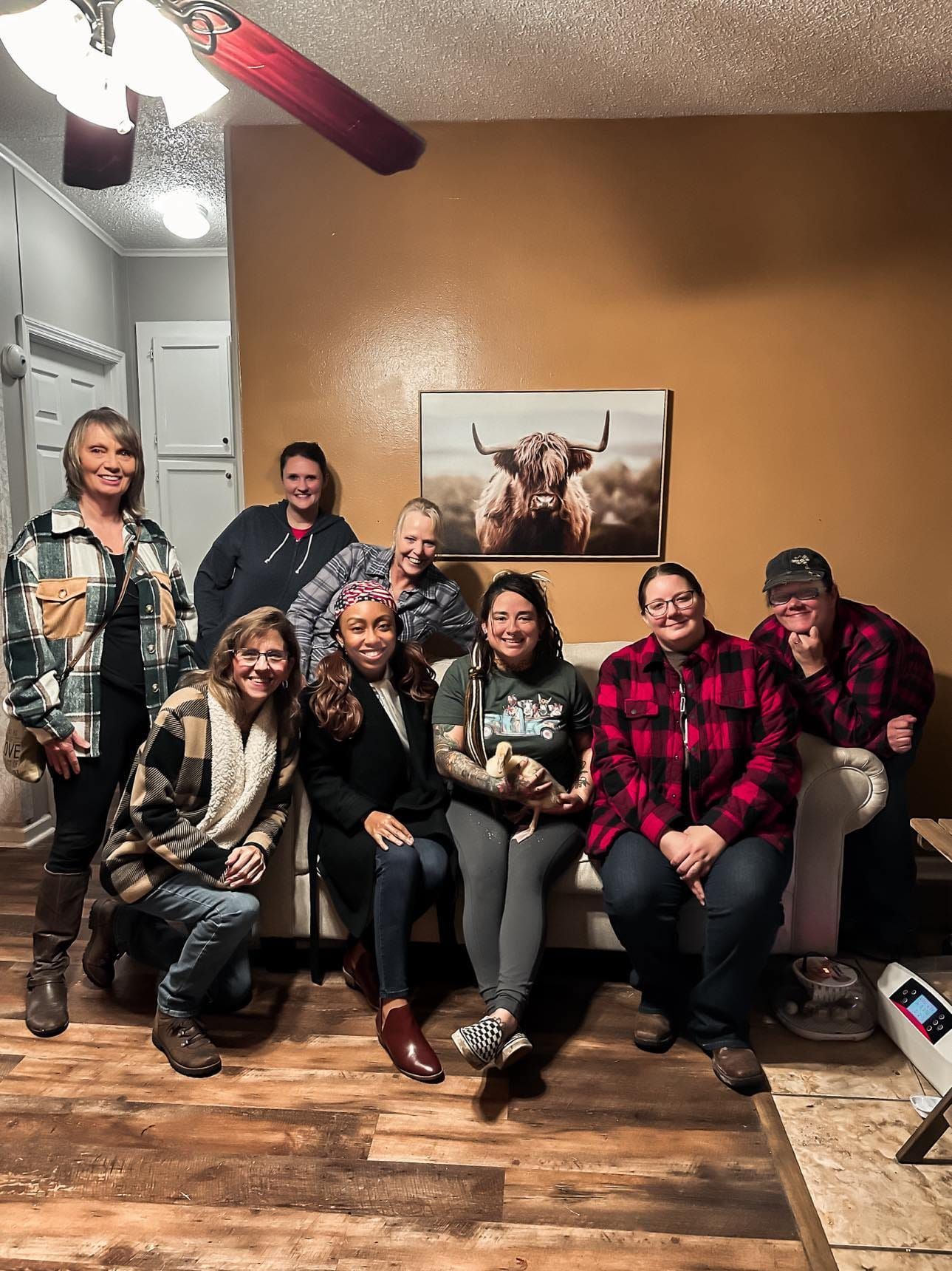 A group of people are sitting on a couch in a living room.