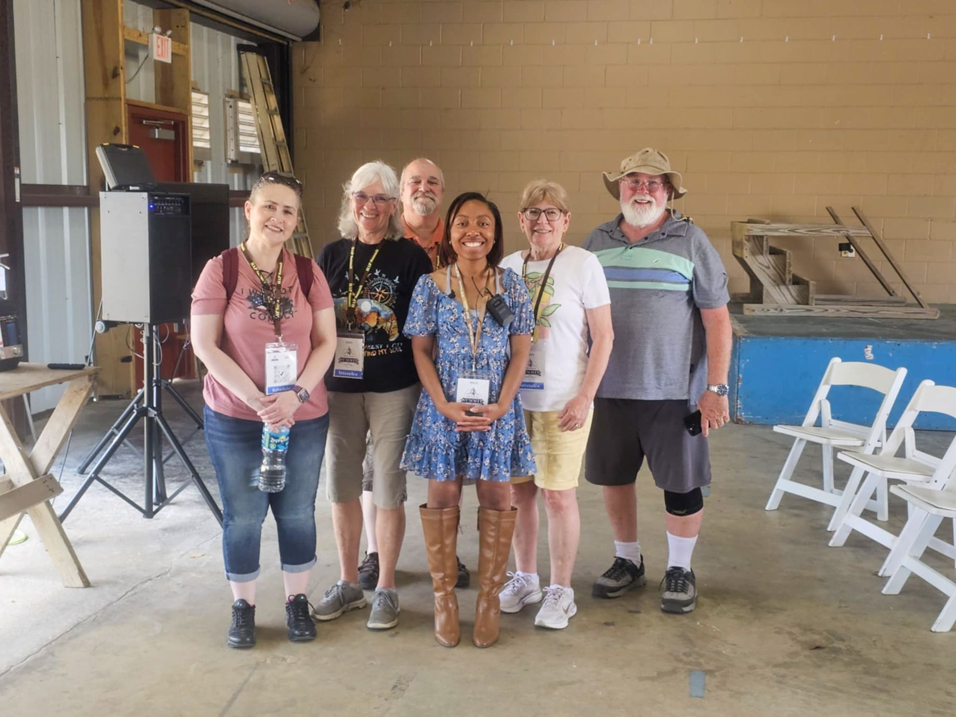 A group of people are posing for a picture in a room.