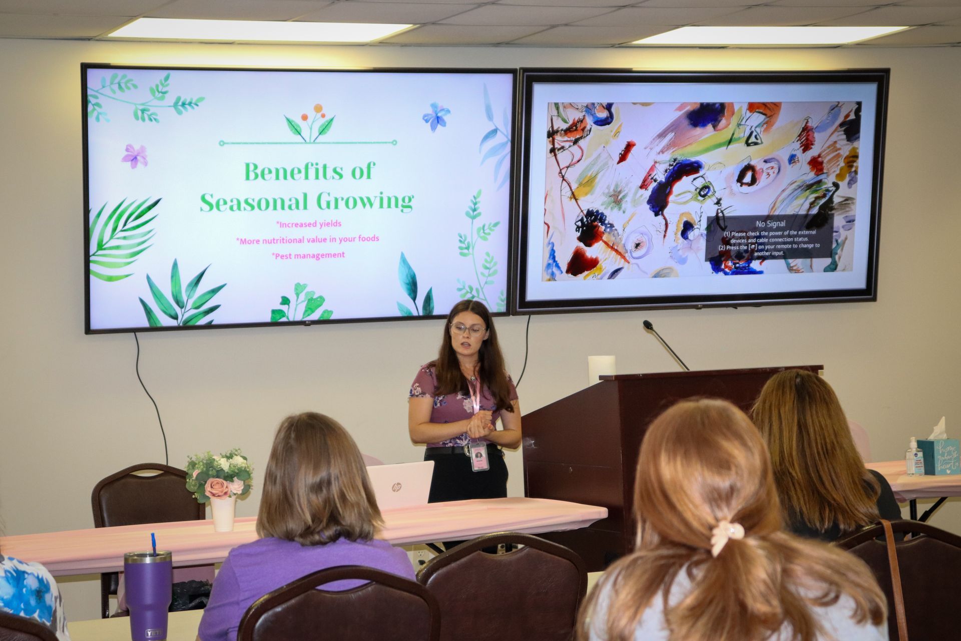 A woman is giving a presentation to a group of people.