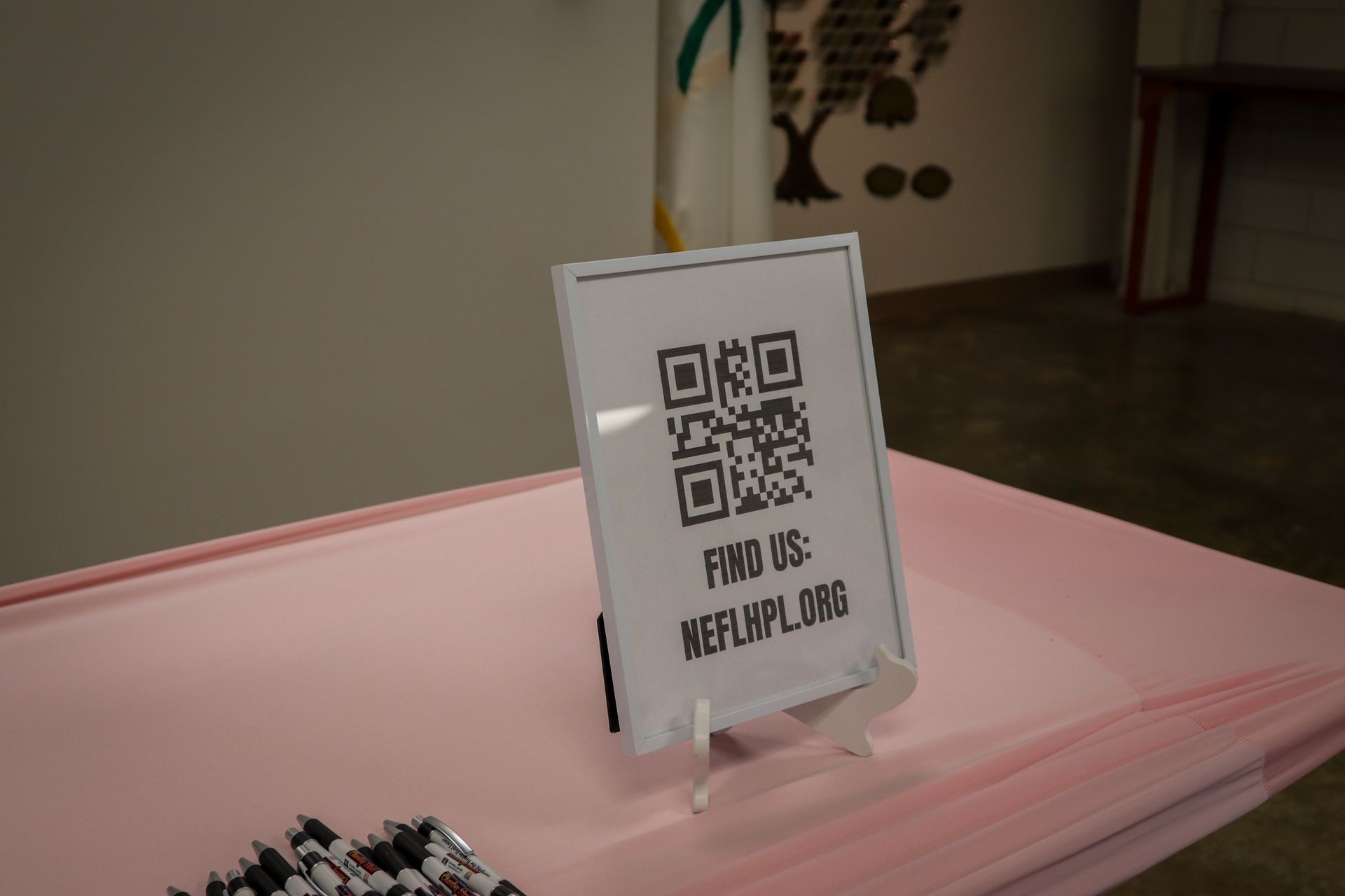 A sign on a table that says find us on it