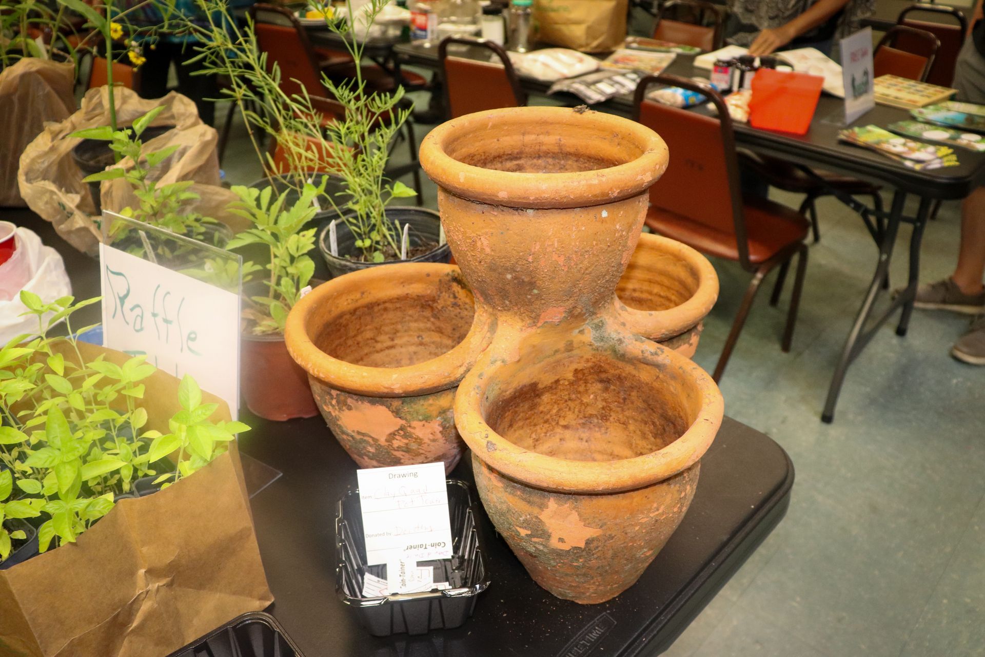 Four clay pots are stacked on top of each other on a table.