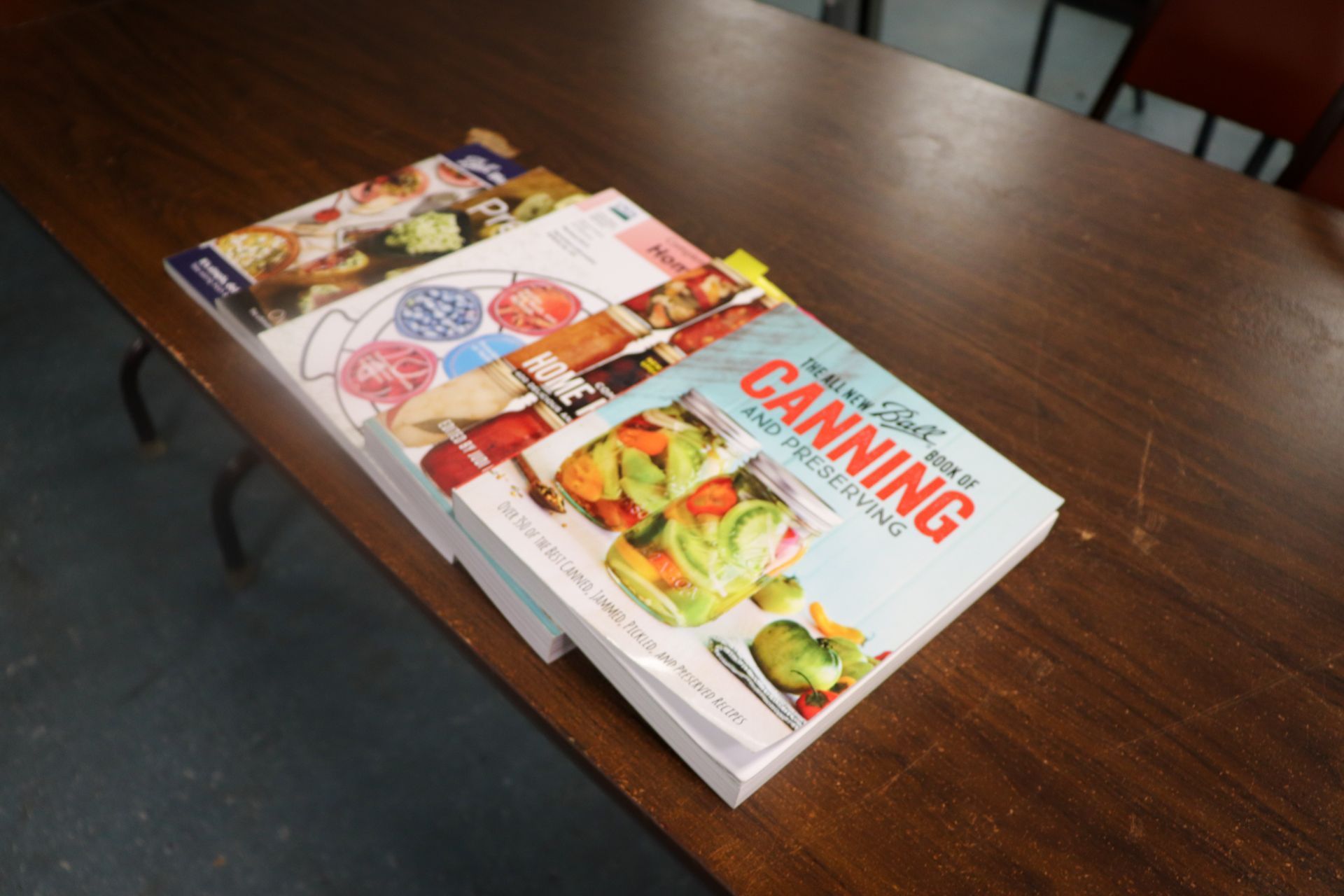 A stack of canning books on a table