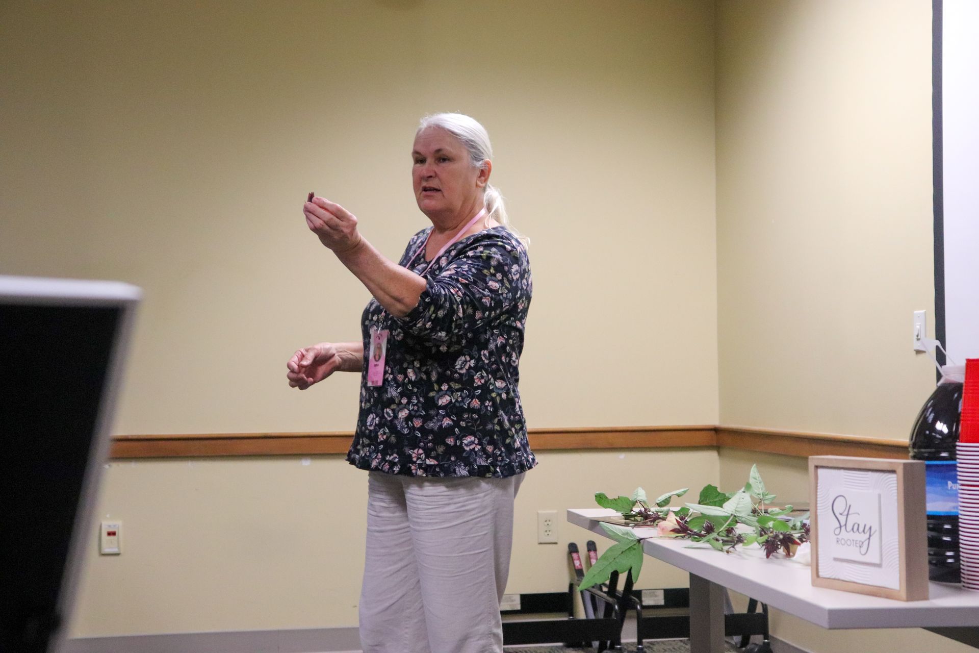 A woman is standing in a room giving a presentation.