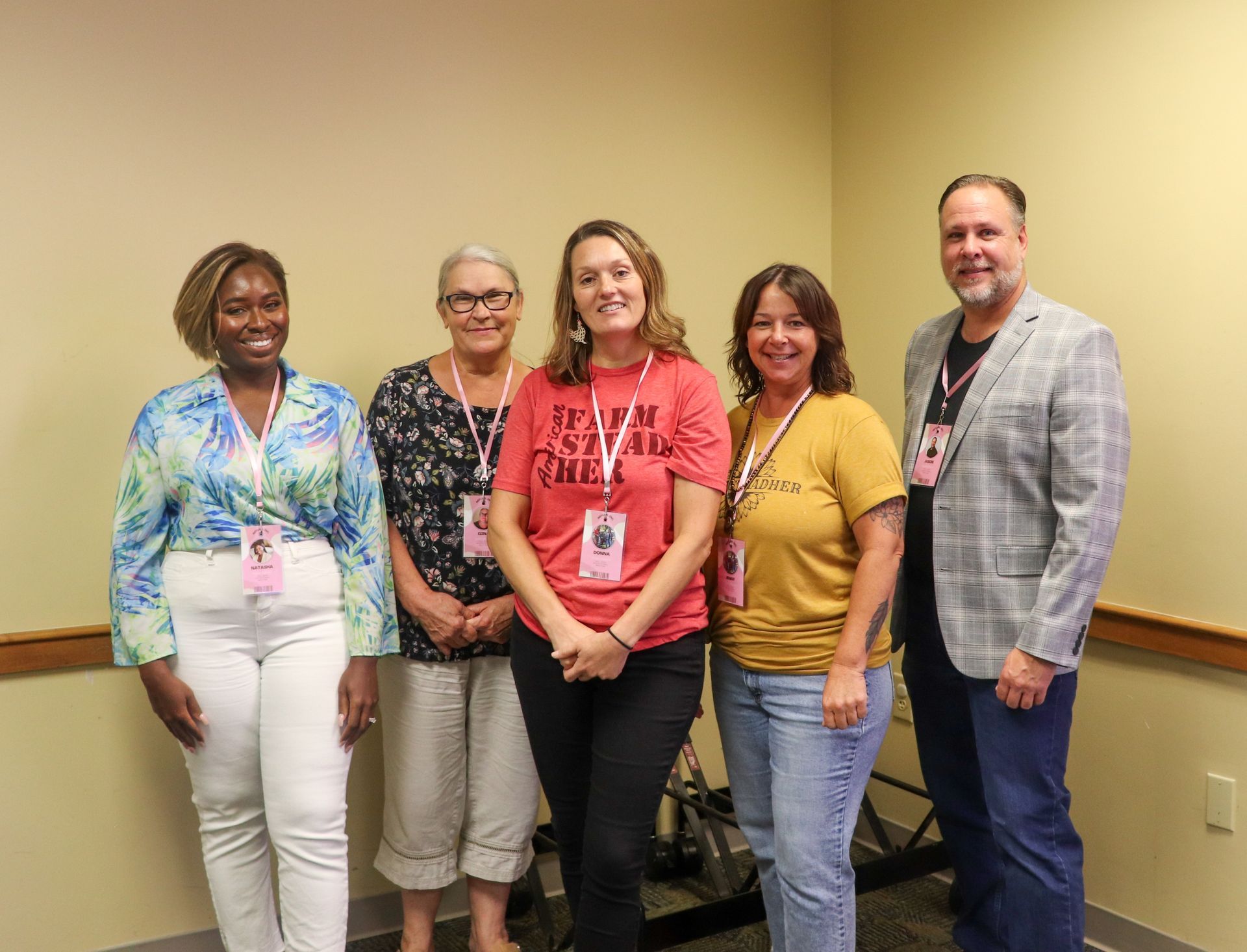 A group of people are standing next to each other in a room.