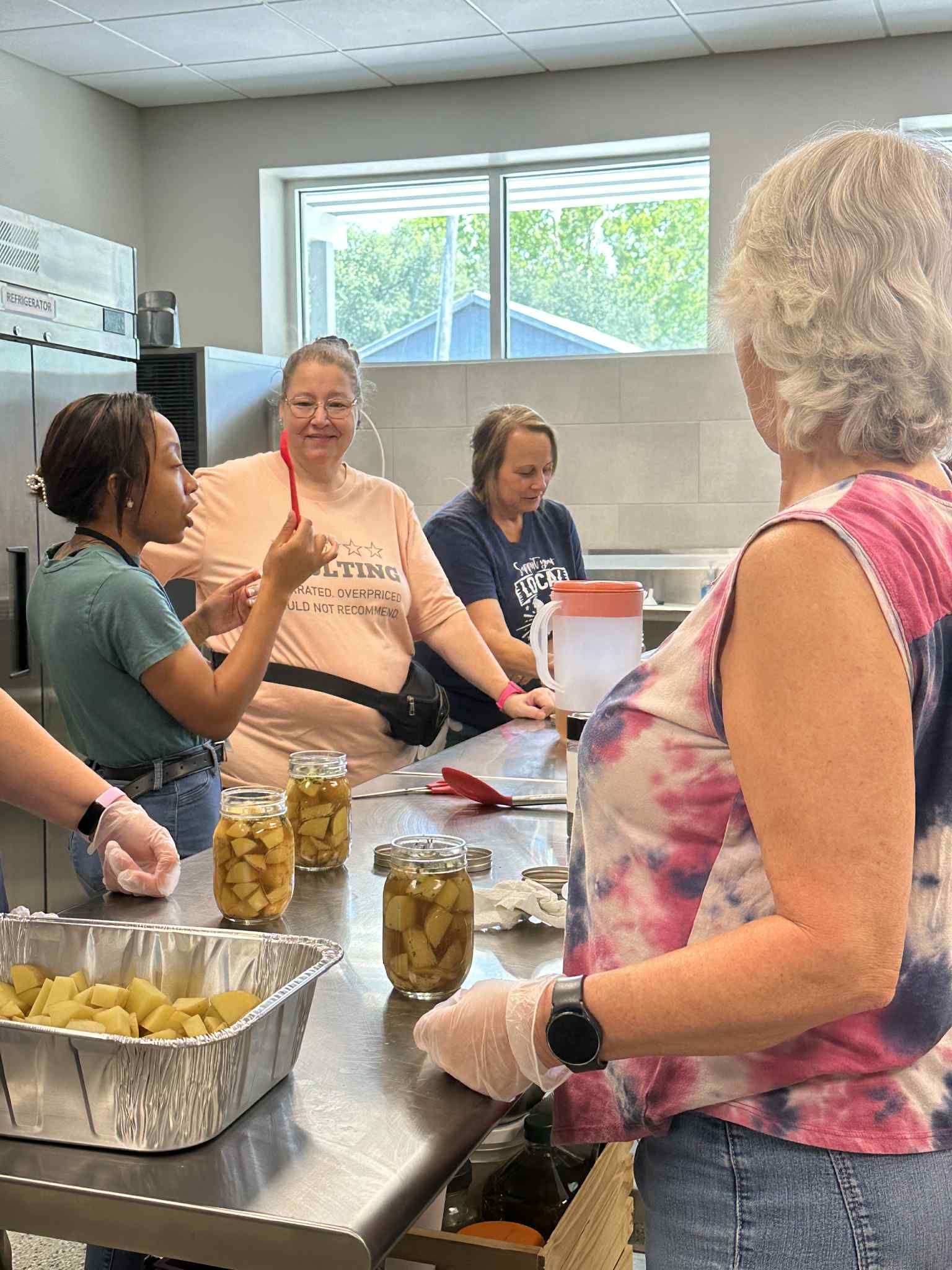 A group of women are preparing food in a kitchen.