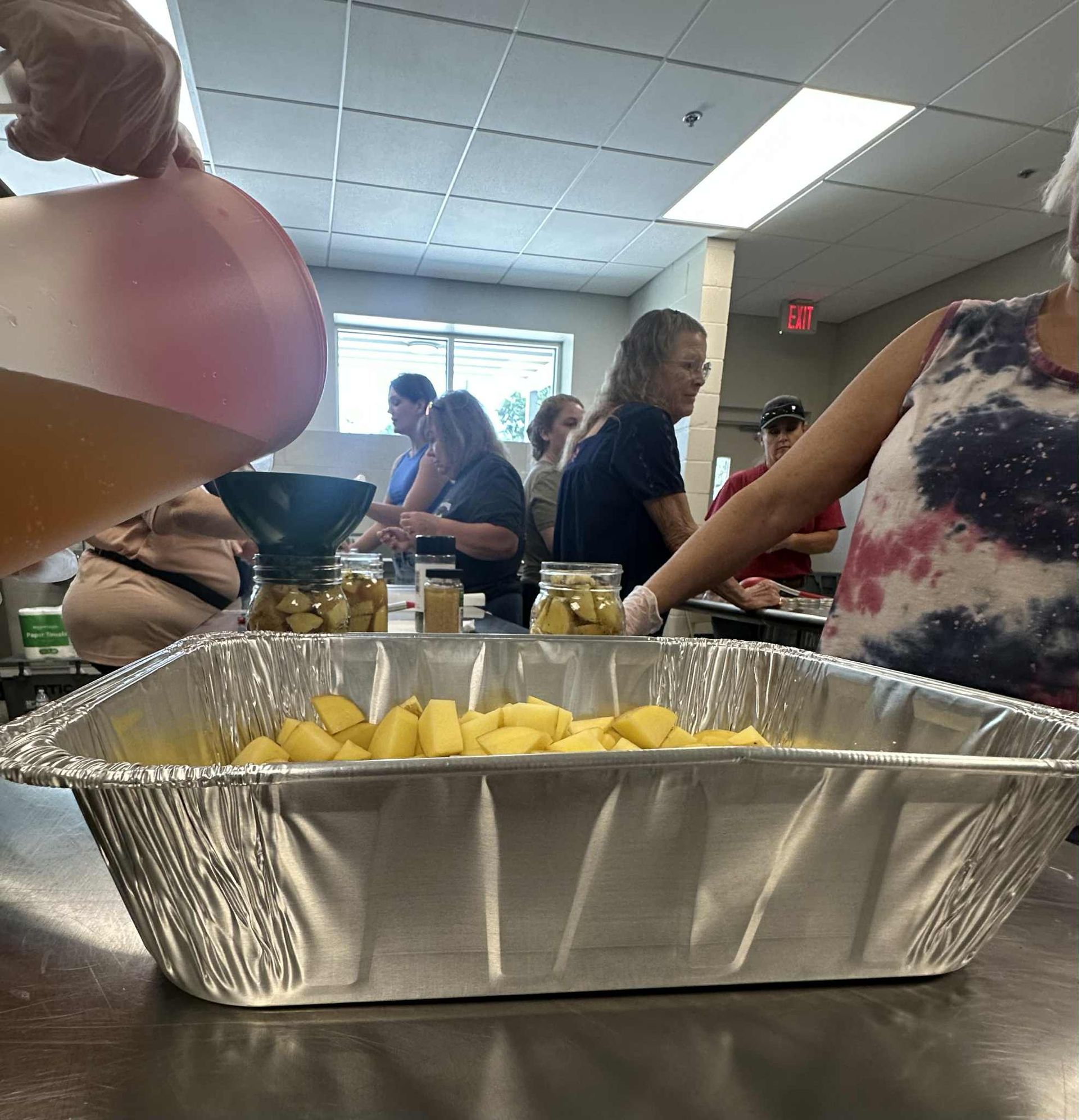 A group of people are preparing food in a kitchen