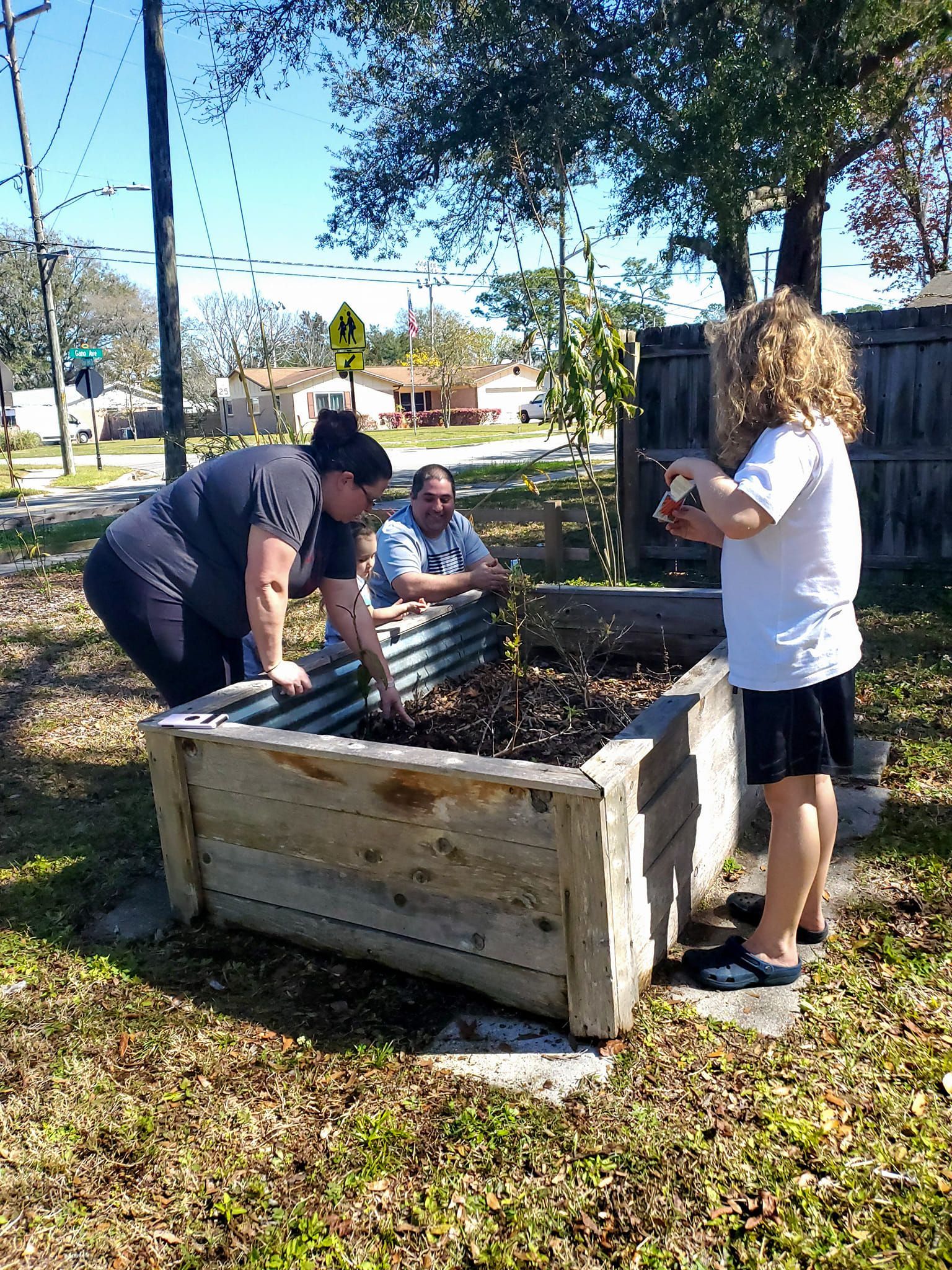 A group of people are working in a garden.