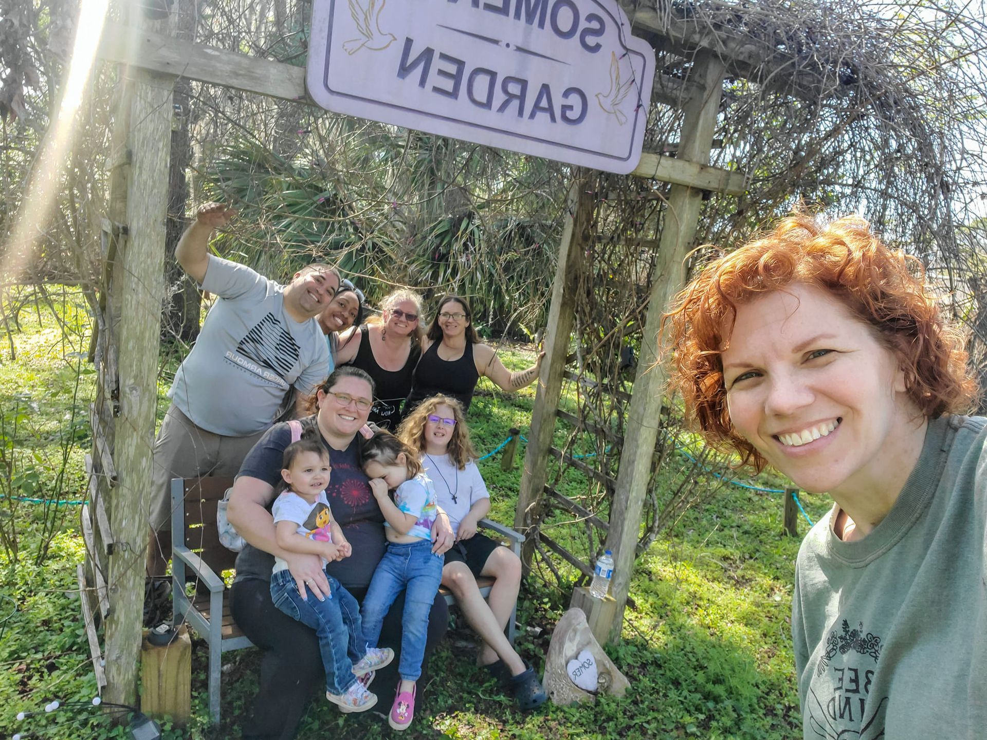 A group of people are posing for a picture in front of a sign.