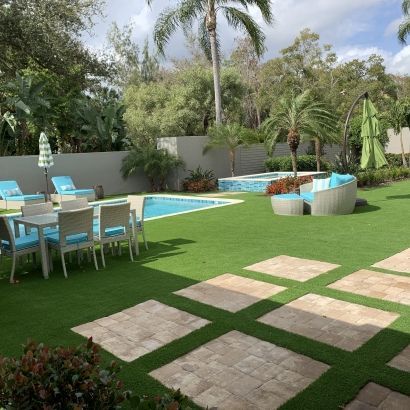 artificial grass and square pavers next to pool