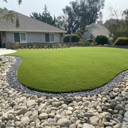 planter full of rock around fake grass