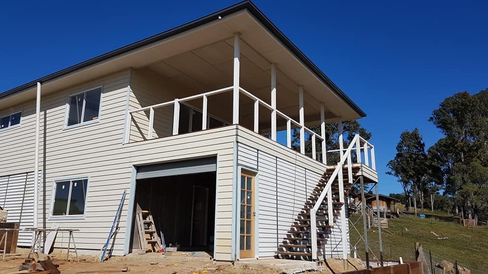 Spacious White Residence Featuring a Balcony and Stairs — Builder In Gympie, QLD